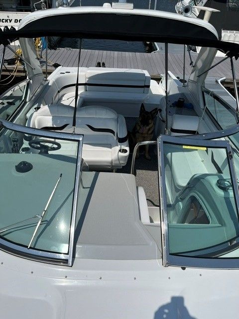 2006 Formula 330 Sun Sport boat with open cockpit and dog on board.