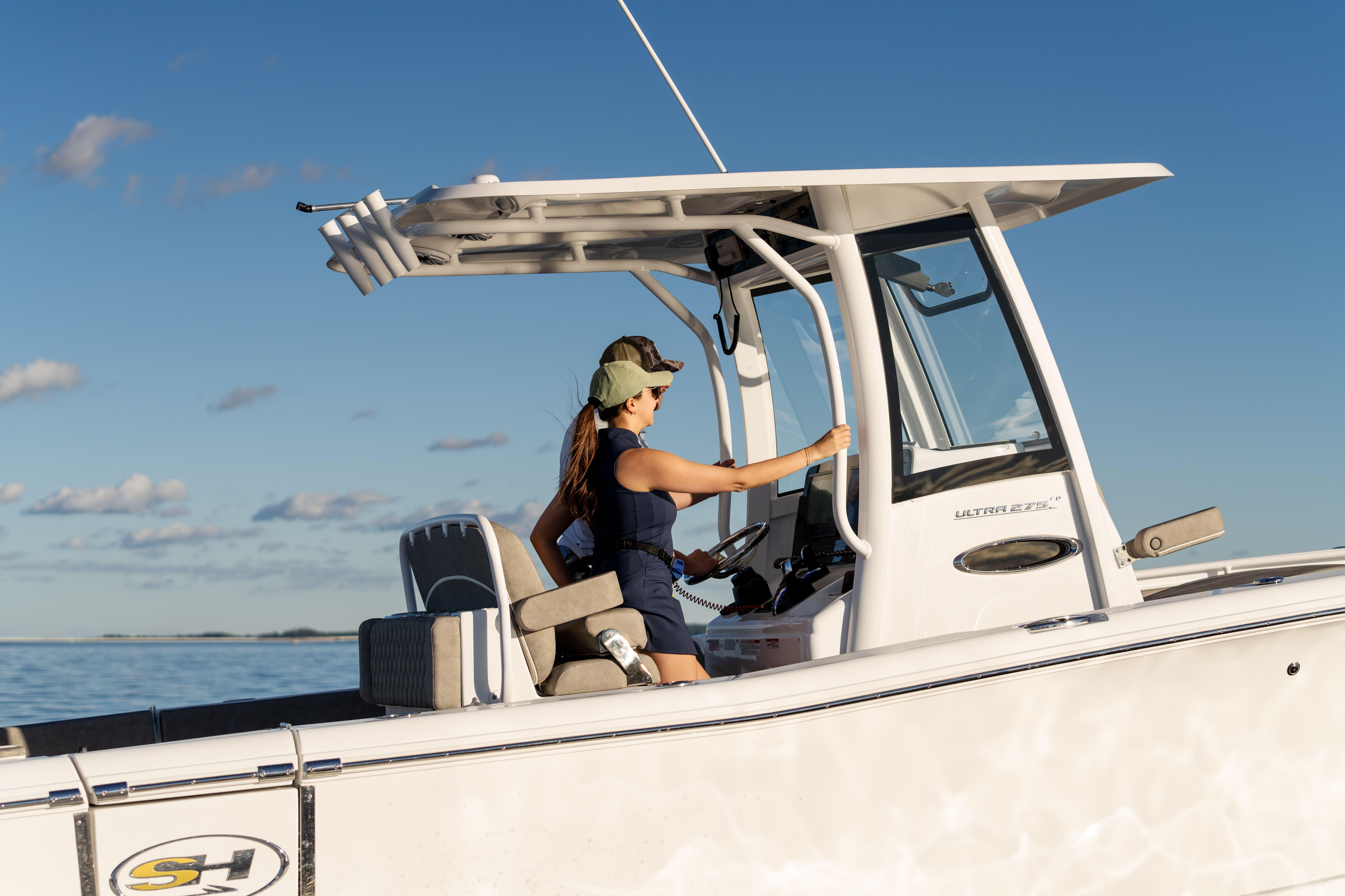 2026 Sea Hunt Ultra 275 Coffin Box boat on calm water, two people navigating.