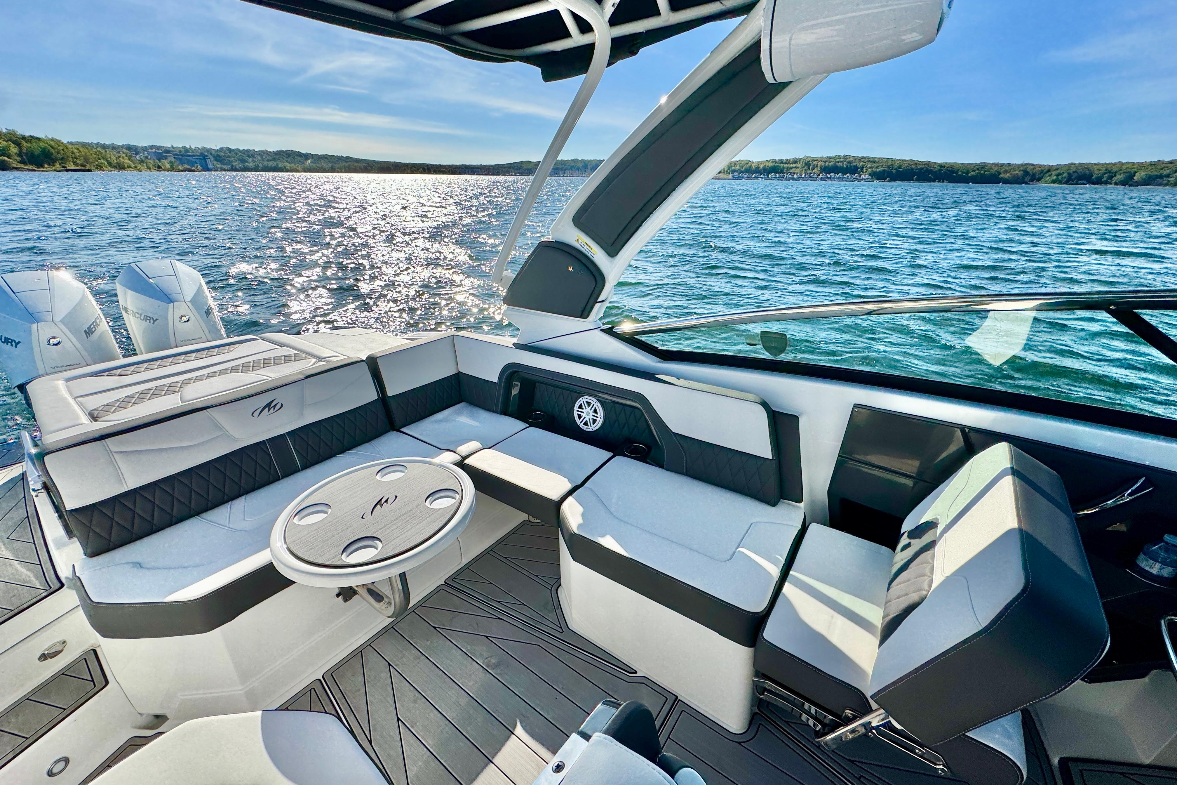 2023 Monterey 305SS Super Sport boat interior with luxurious seating and scenic water view.