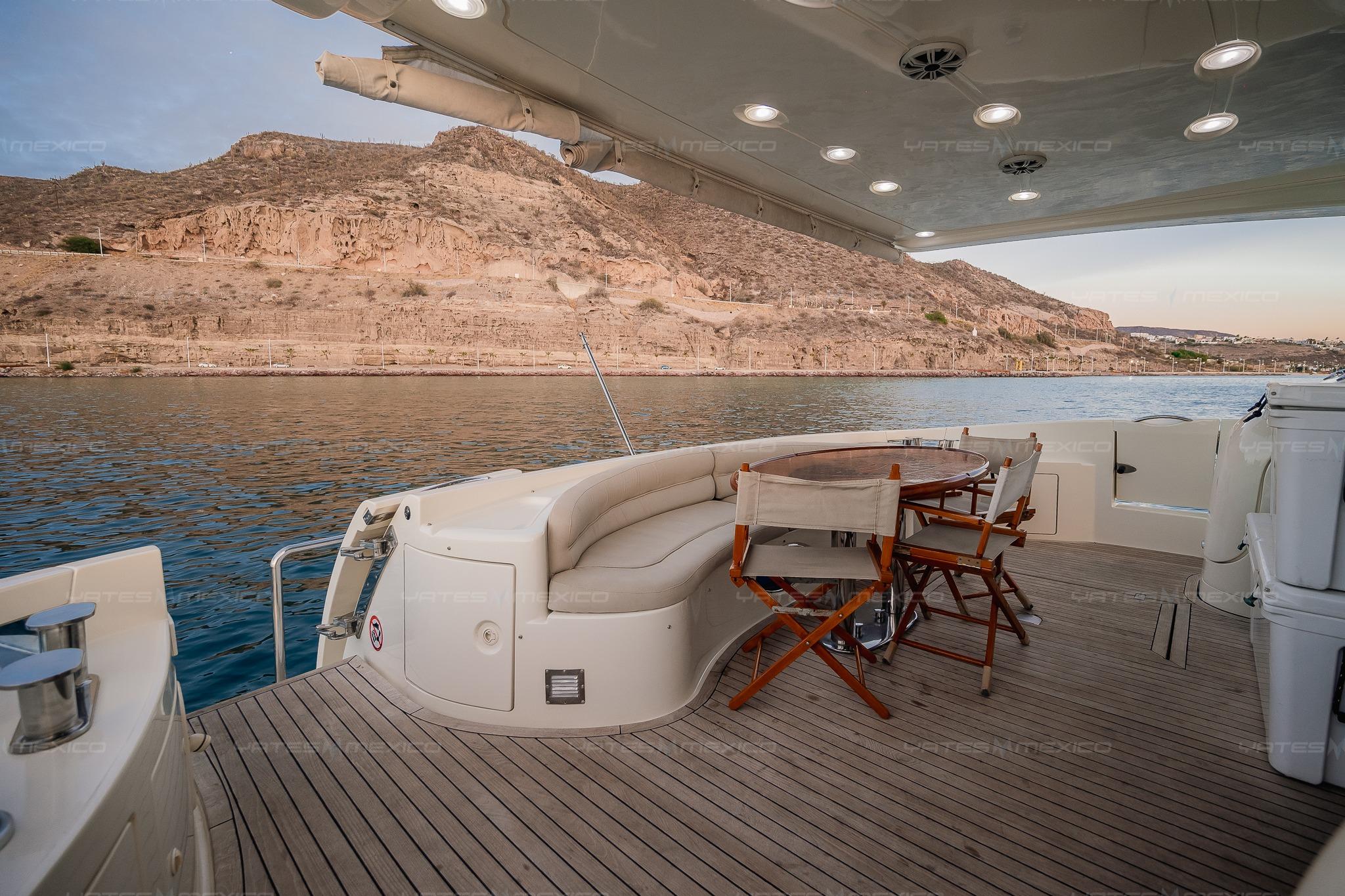 Luxurious 2004 Azimut 68 Plus yacht deck with scenic coastal view.