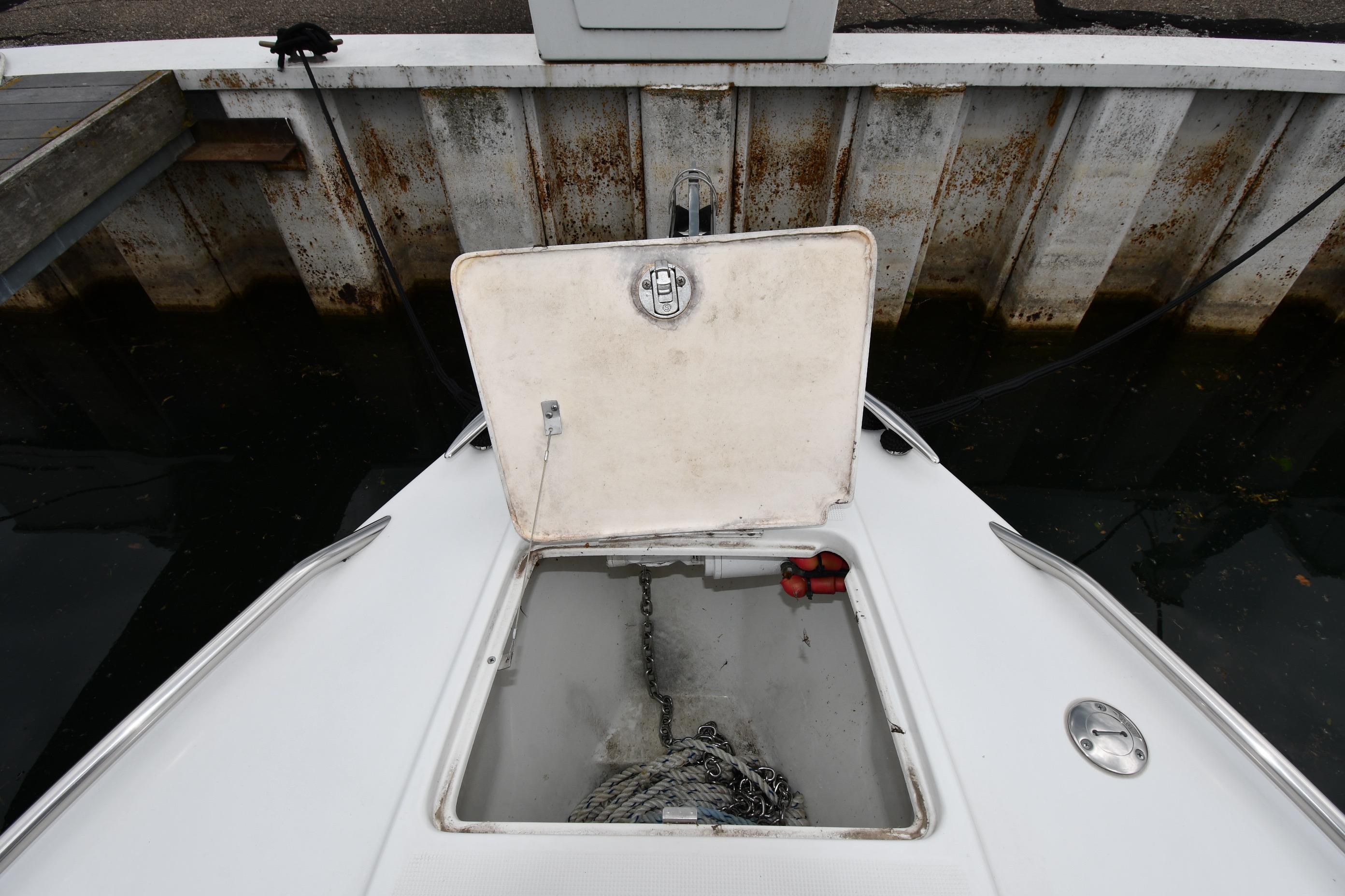 Open anchor compartment on 2004 Formula 330 Sun Sport boat at dock.