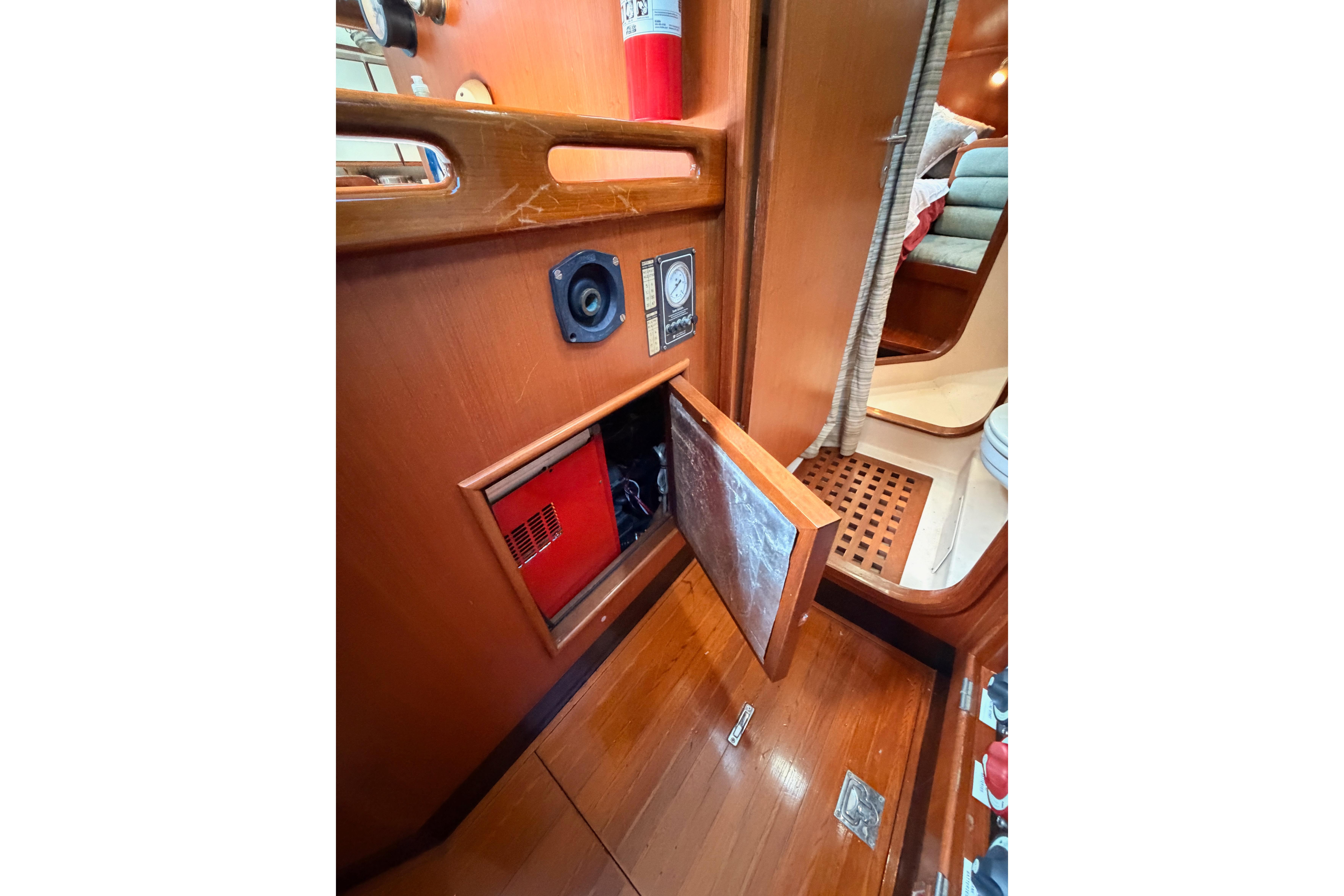 Interior of 1991 Hylas 51 yacht showing wooden paneling and storage compartment.