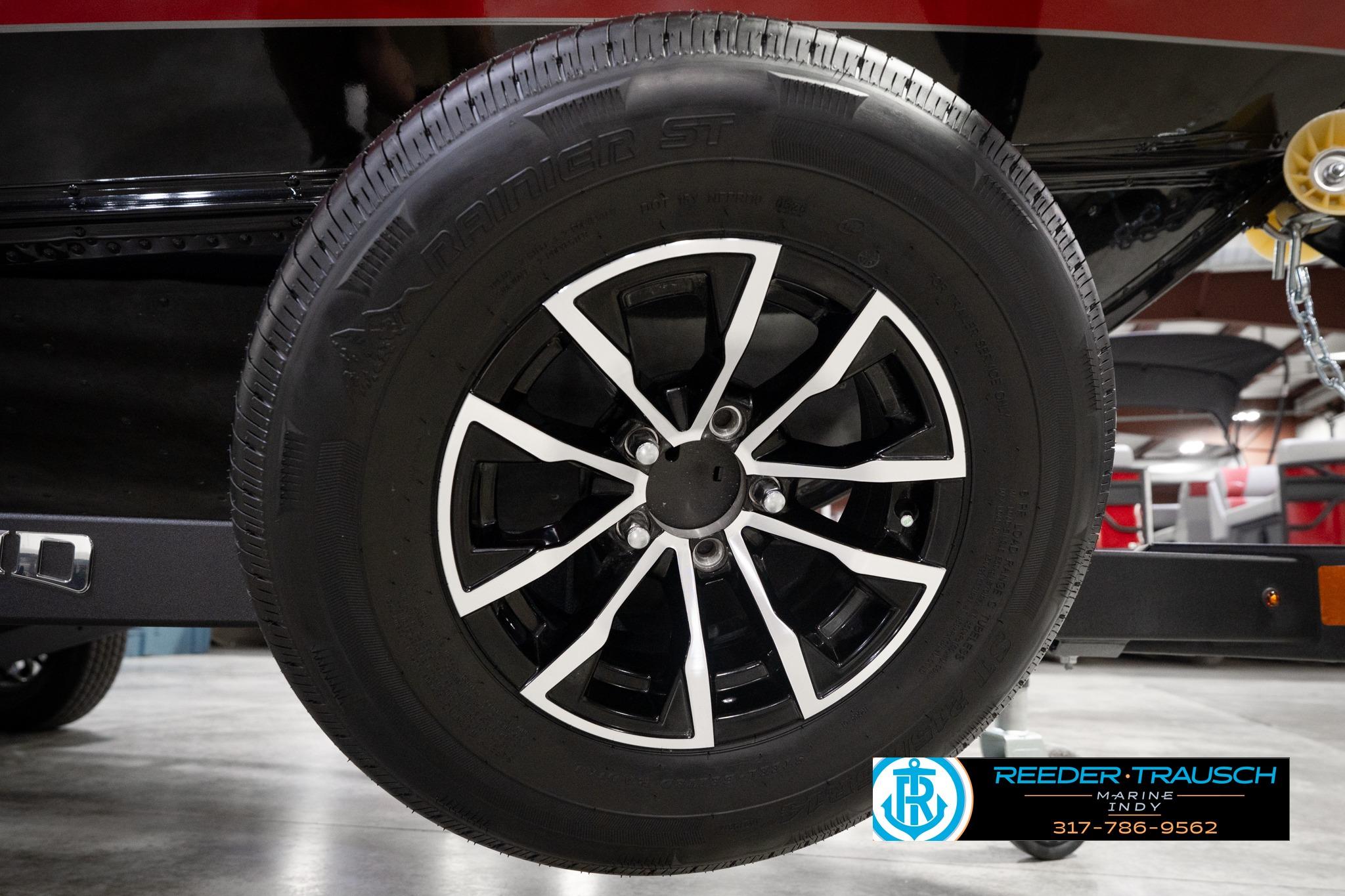 Close-up of a 2026 Lund 1775 Impact XS SS boat trailer wheel.