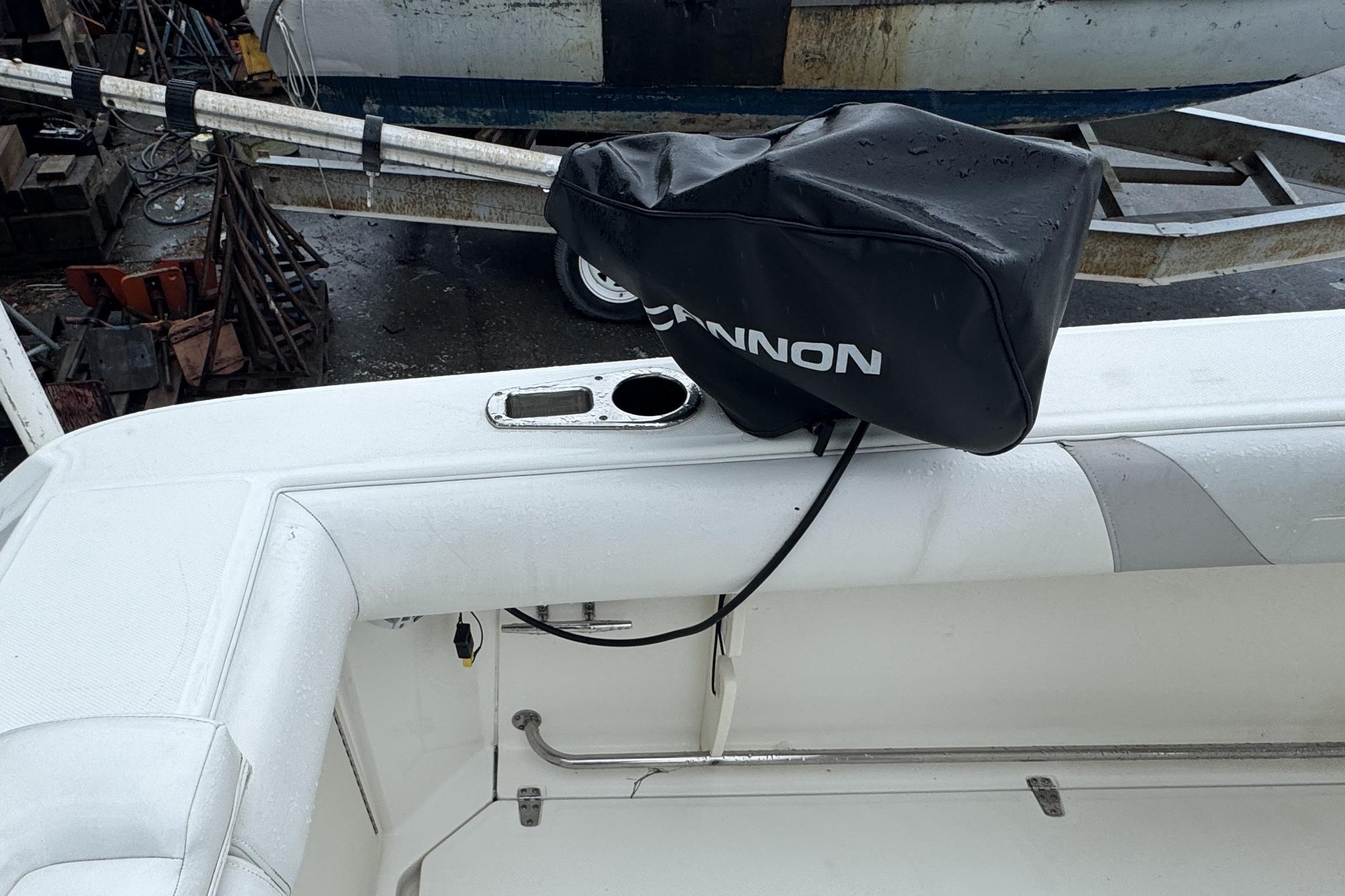 2014 Boston Whaler 250 Outrage boat deck with covered equipment and rod holder.