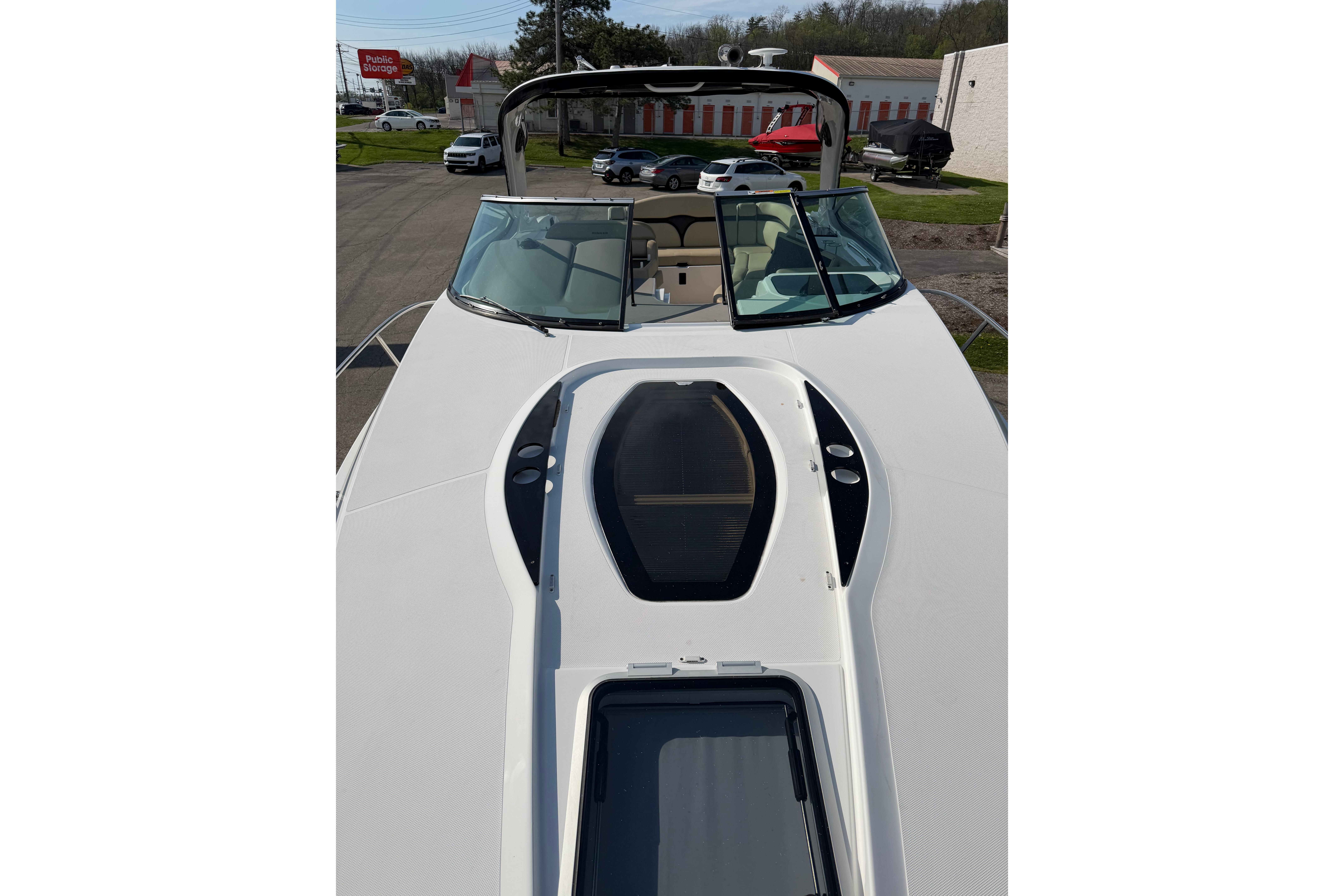 2019 Rinker EX 320 boat deck with windshield and seating area.