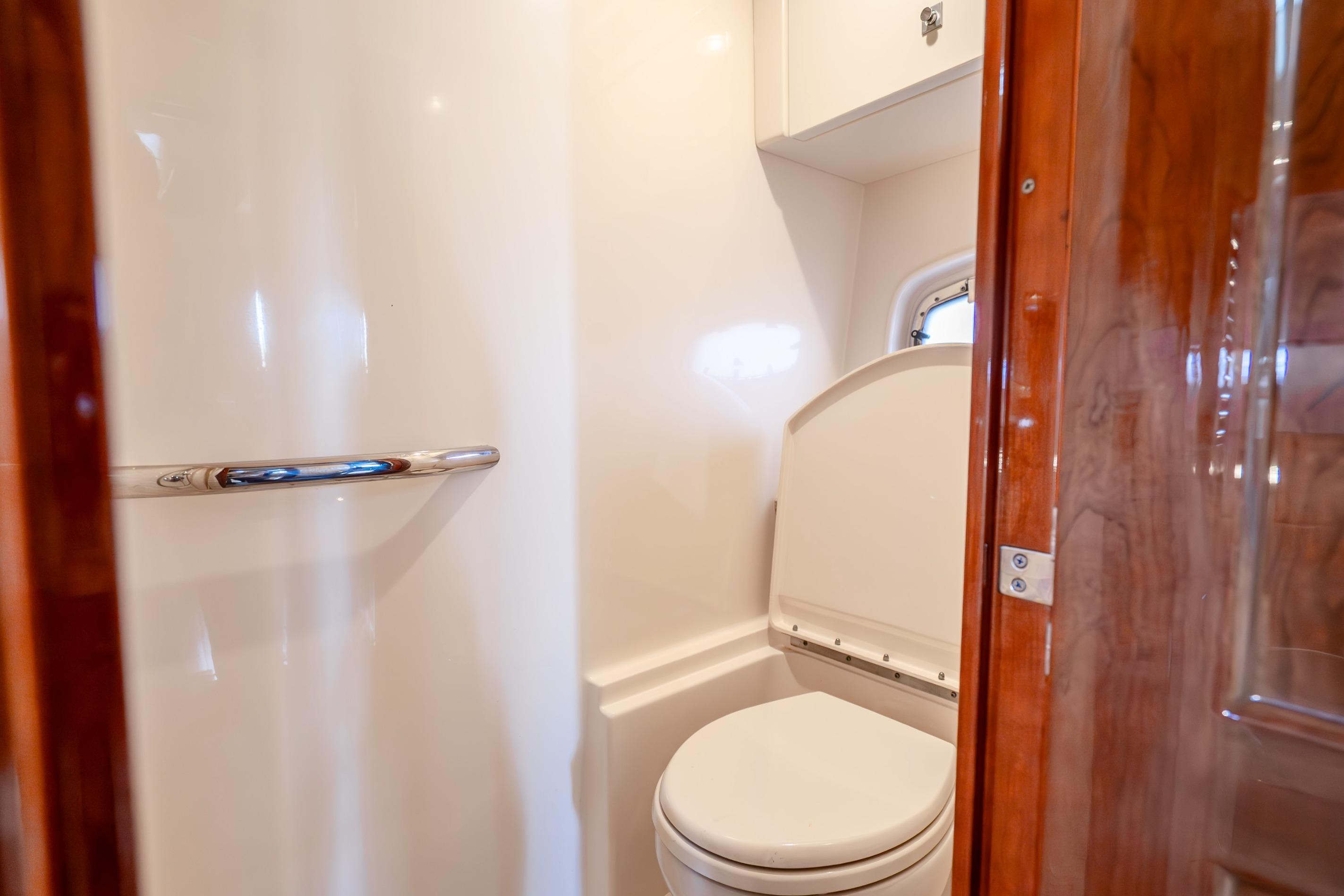 2009 Sea Ray 470 Sundancer yacht bathroom with modern fixtures and wooden accents.