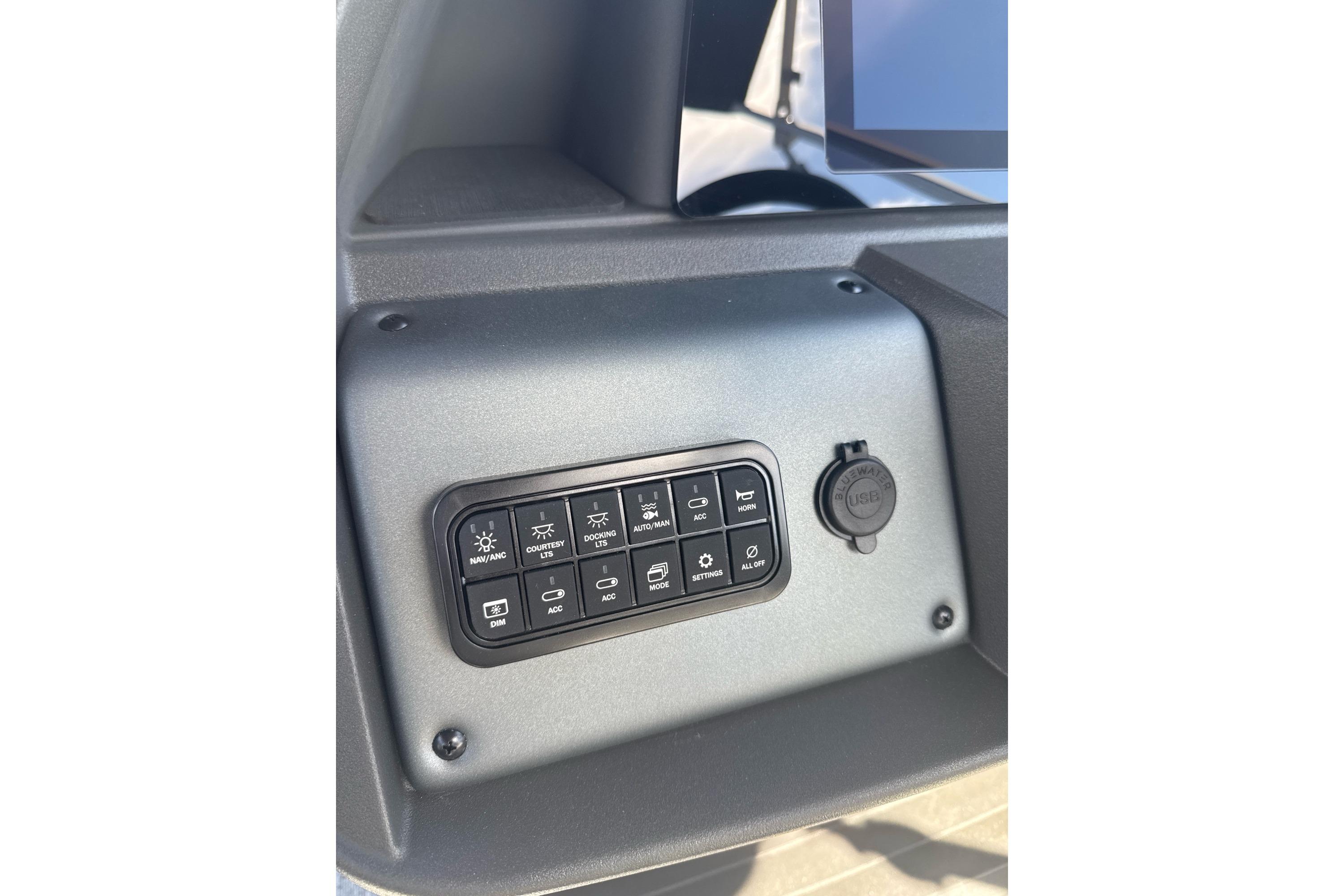 Control panel of 2026 Sun Tracker Fishin' Barge 20 DLX boat with various switches.