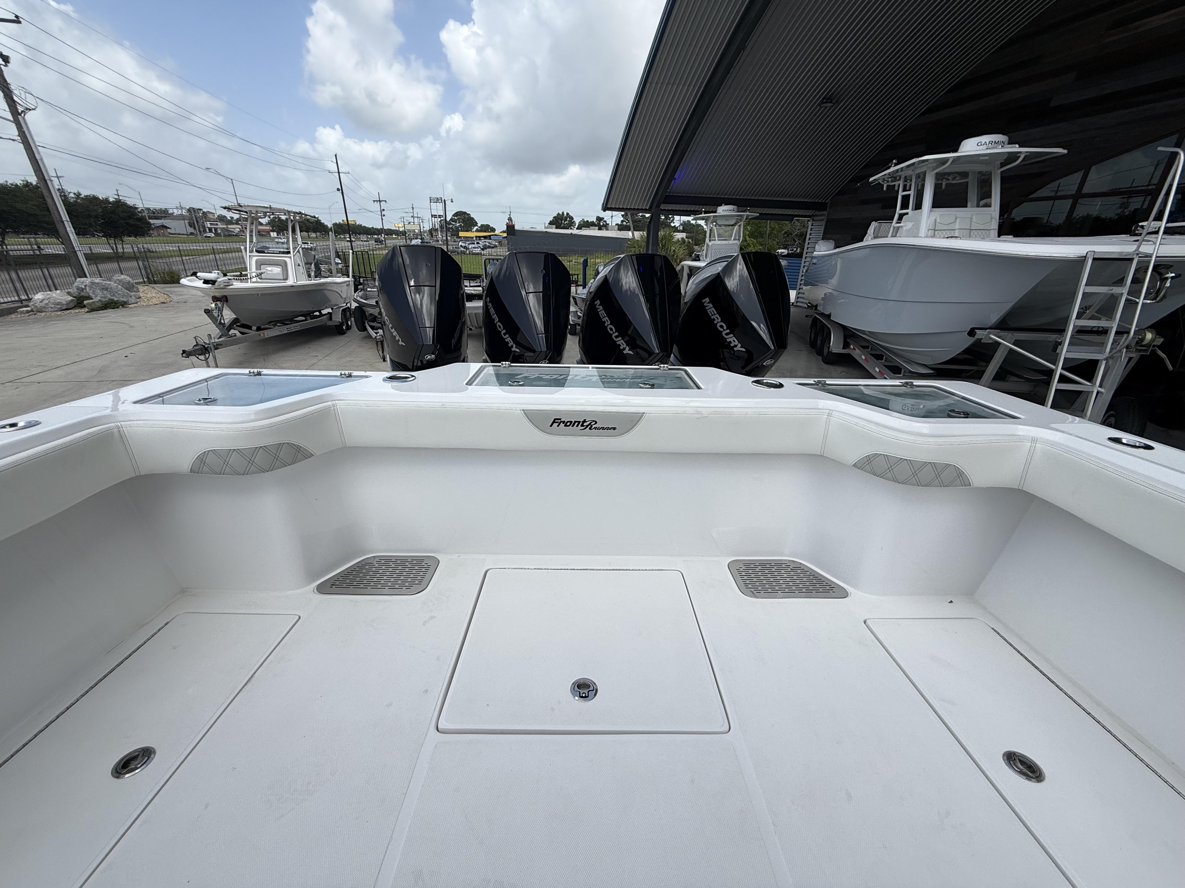 2024 Front Runner 39 CC boat with multiple outboard engines, docked under a cloudy sky.