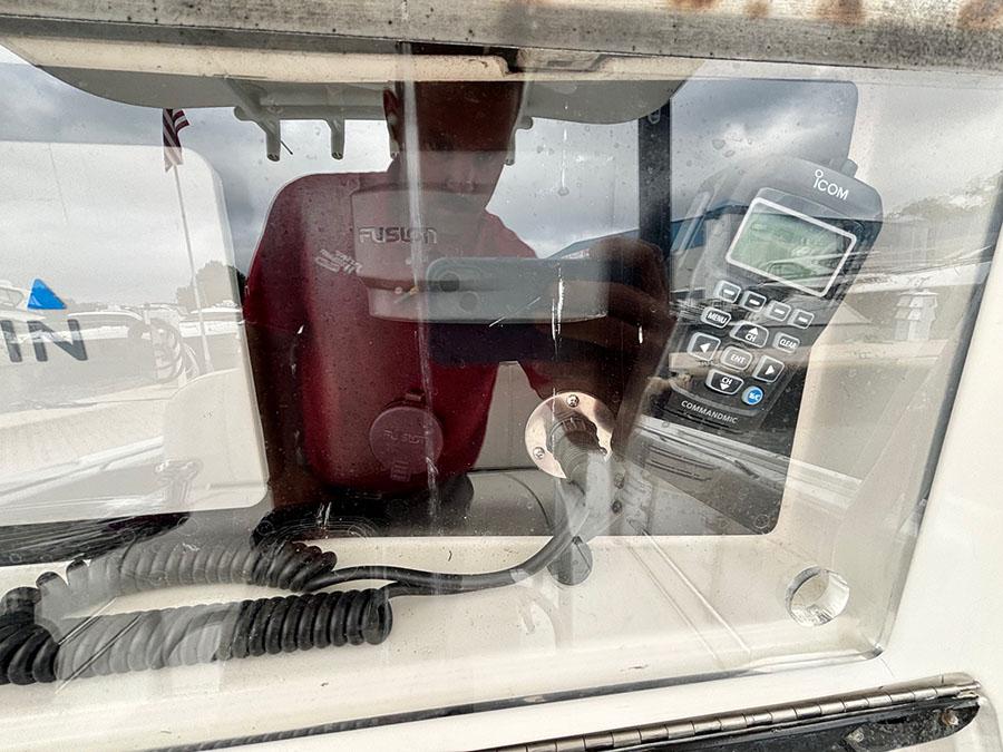 2003 Marlago FS35 boat dashboard with radio and coiled cables.