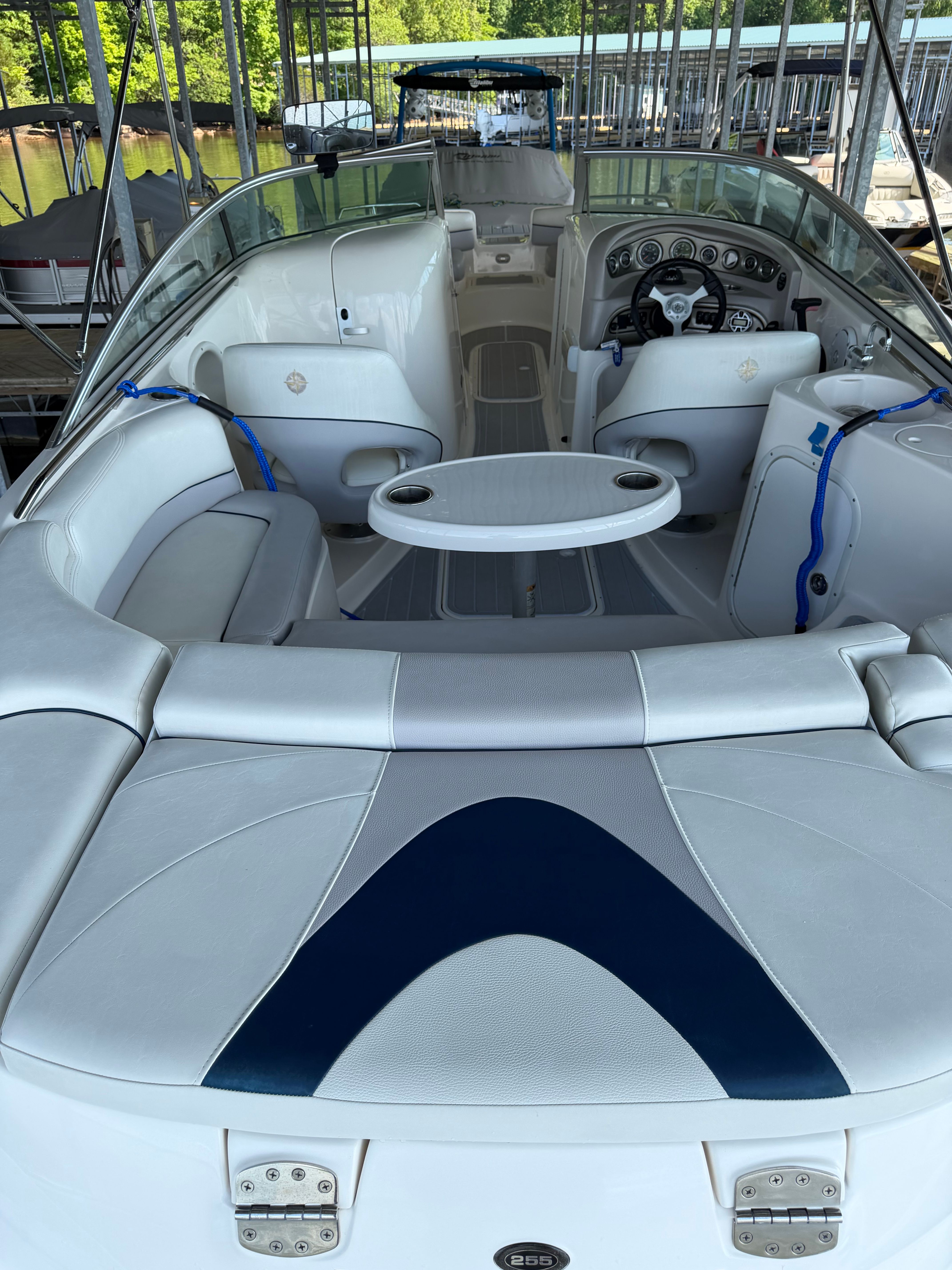 Interior of a 2010 Bryant 255 boat with white leather seating.