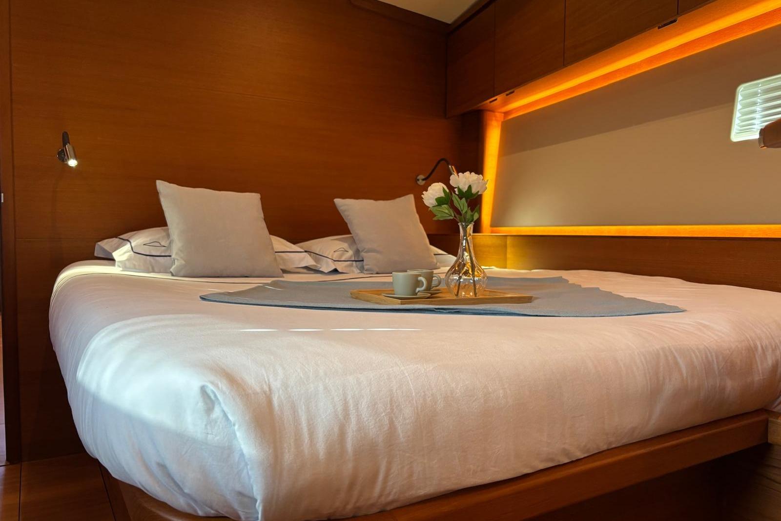 Luxurious bedroom interior of 2022 Solaris 55 yacht with elegant lighting and decor.