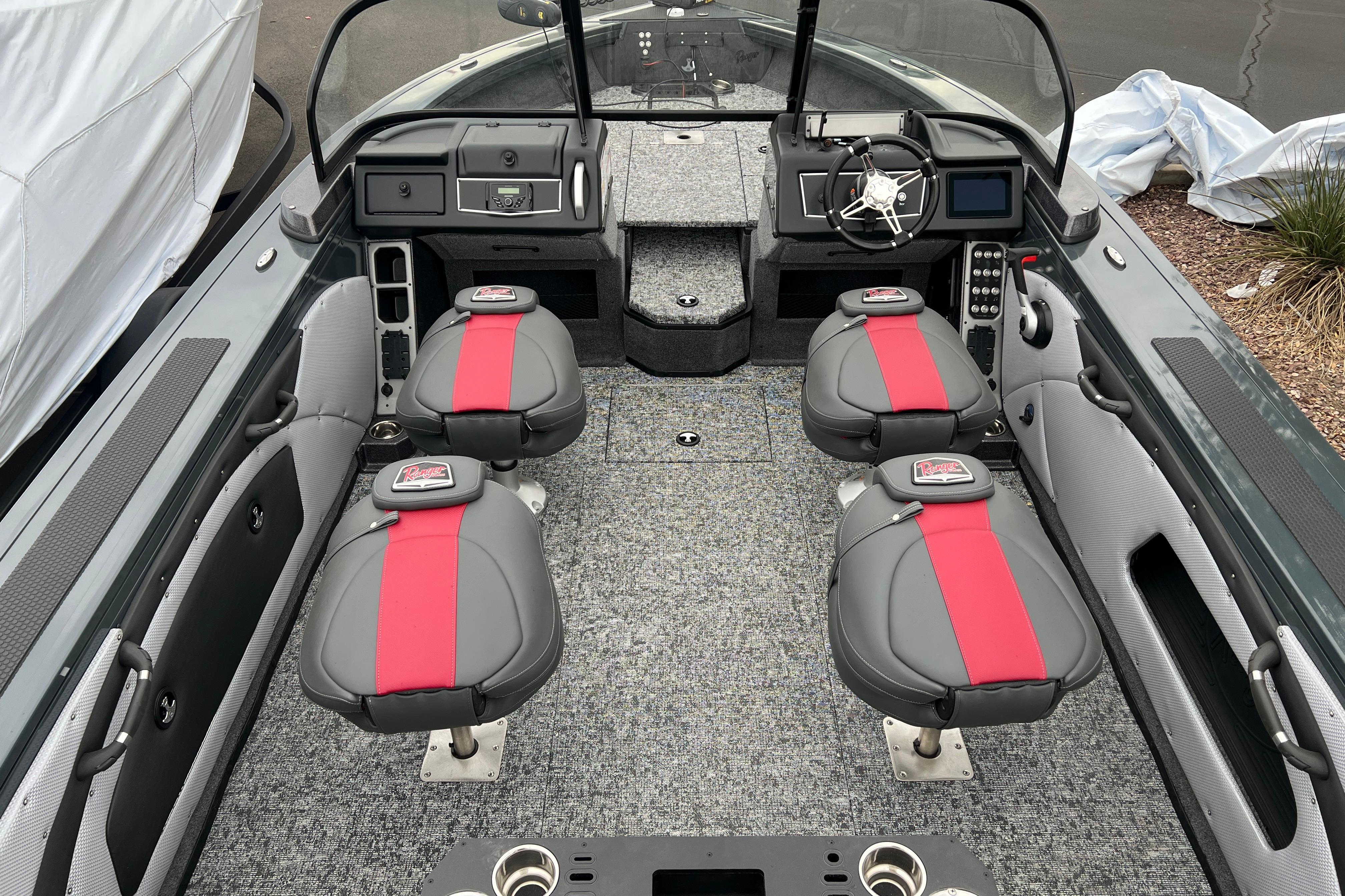 2026 Ranger VX1988 WT boat interior with four seats, red accents, and modern dashboard.