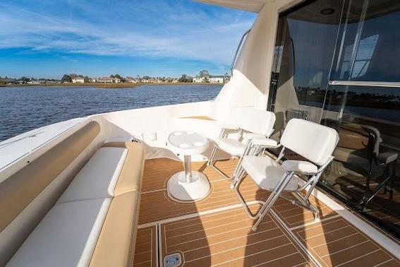 2006 Sea Ray 580 Sedan Bridge yacht deck with seating and scenic water view.