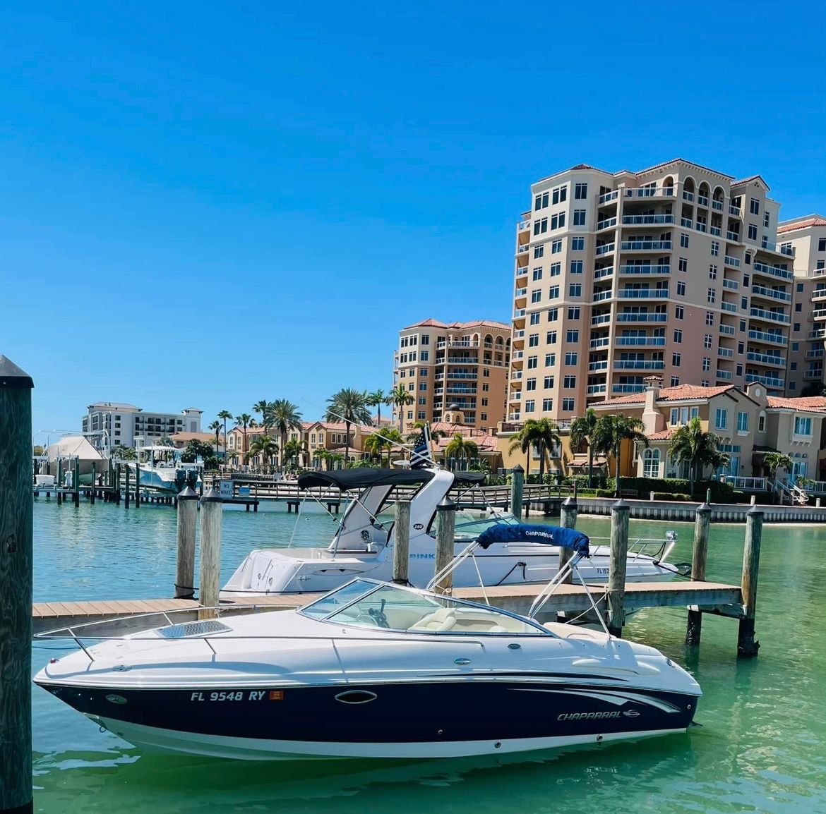 A 2007 Chaparral 235 SSi boat docked in a sunny harbor.