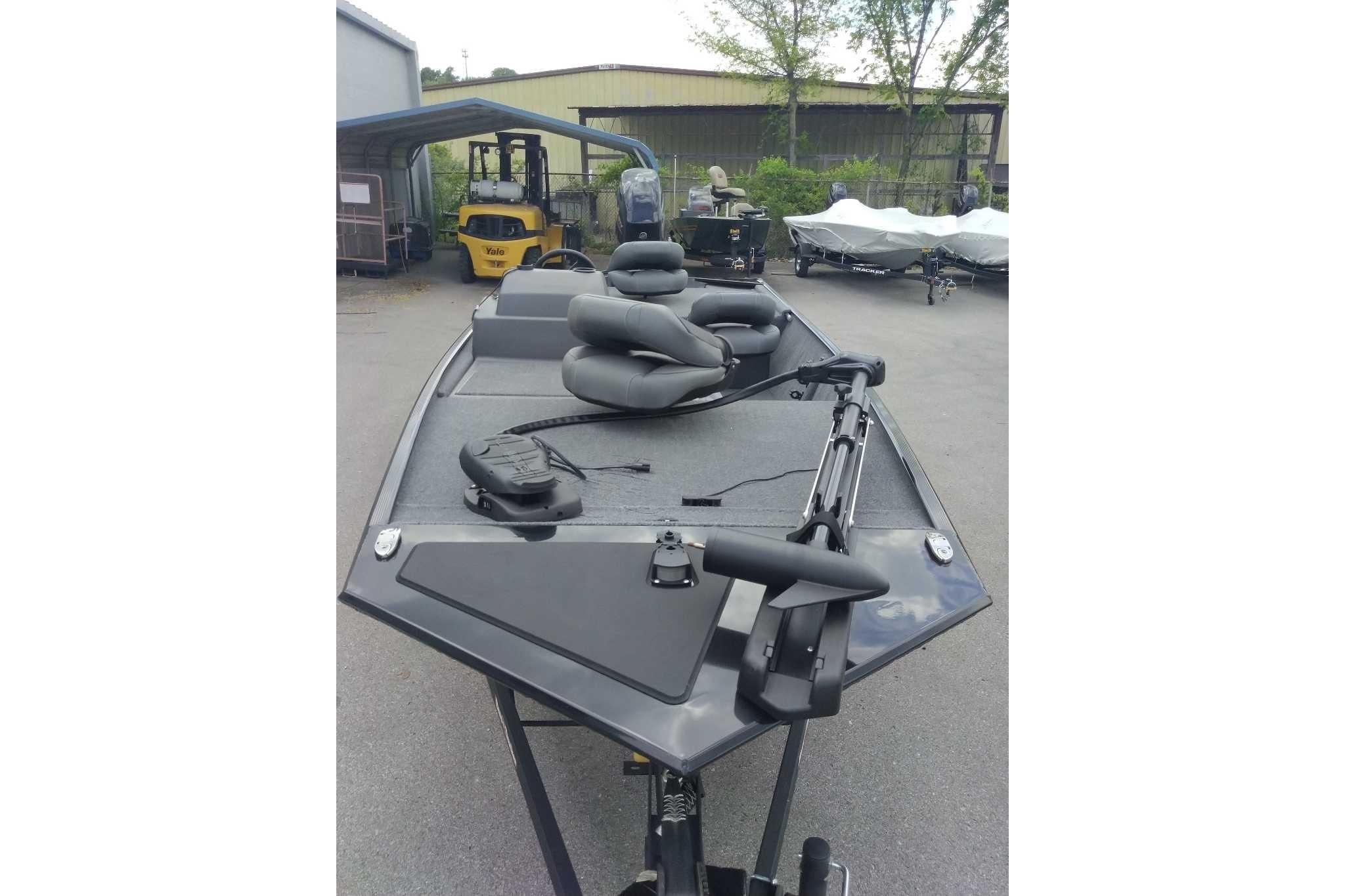 2026 Tracker Bass Tracker Classic XL boat with seating, parked outdoors.