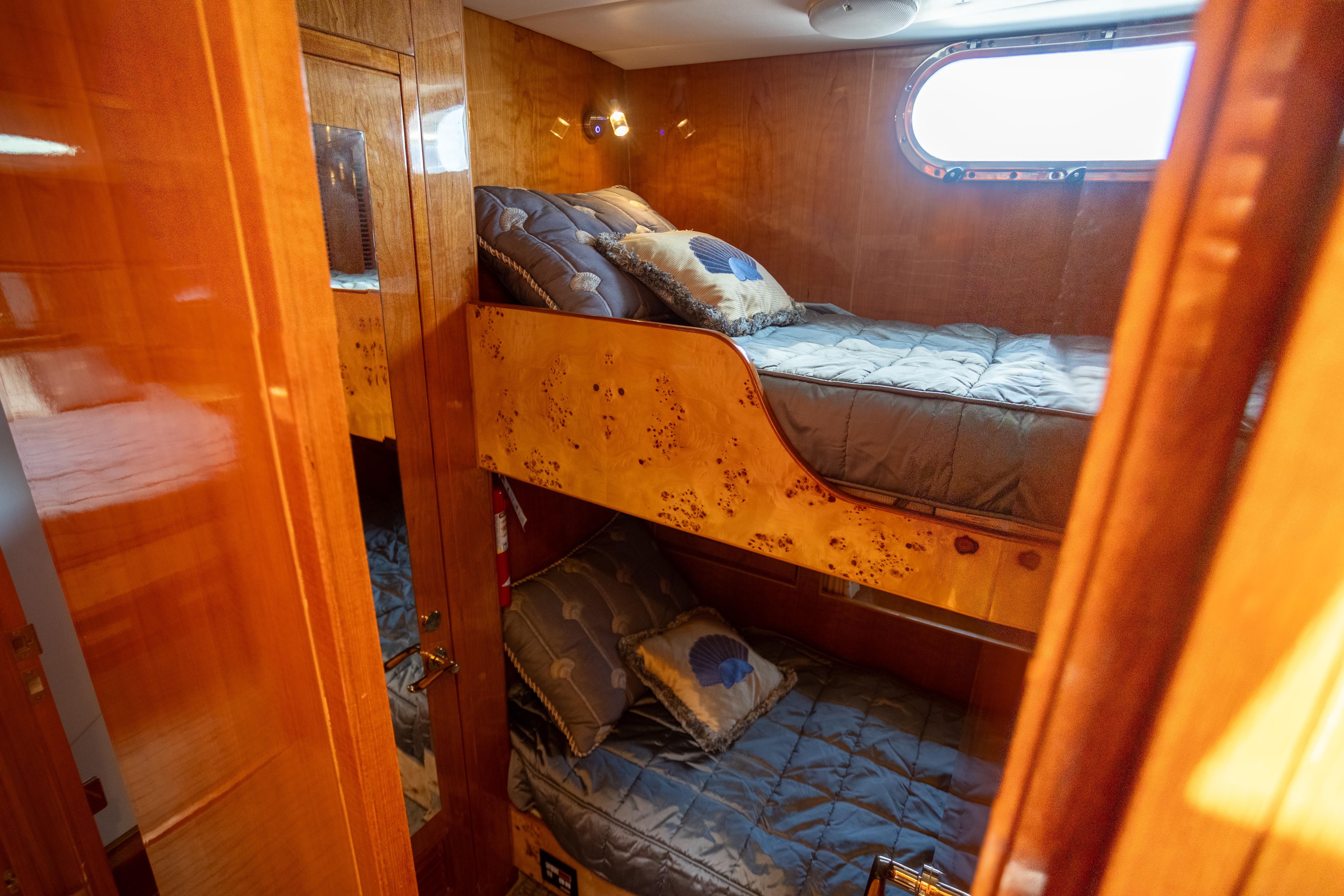 Luxurious wooden cabin with bunk beds in a 2001 Vitech 72 yacht.
