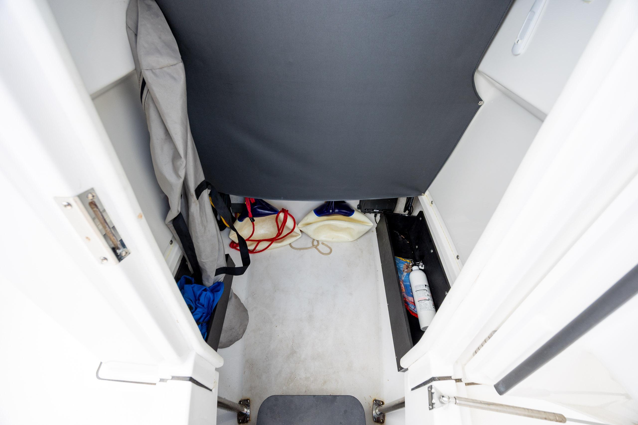 Interior storage area of a 2019 Blackfin 212 CC boat with safety equipment.
