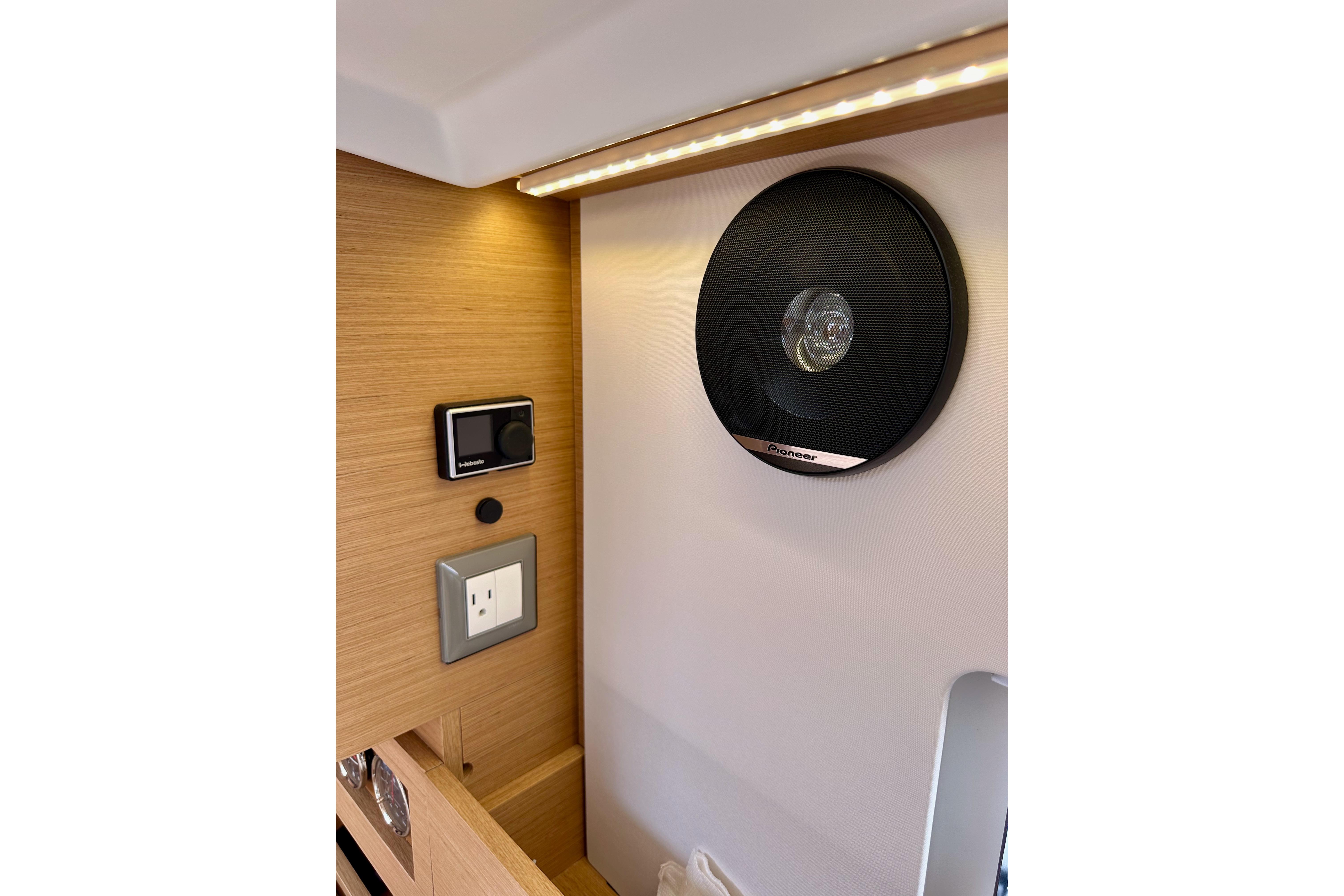 Interior of 2024 Jeanneau Sun Odyssey 410 with speaker and control panel.