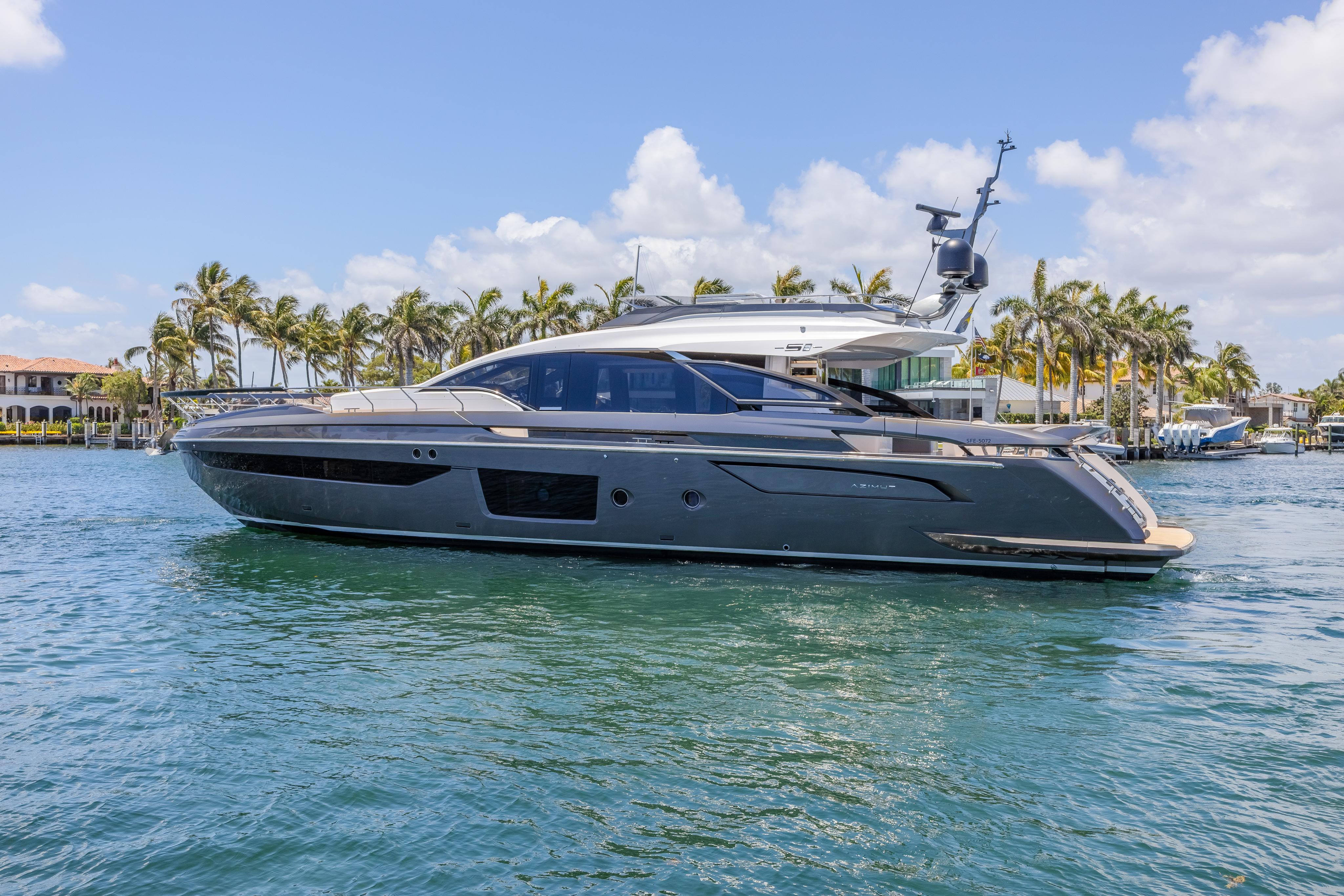 2023 Azimut S8 yacht cruising on a sunny day with palm trees in the background.