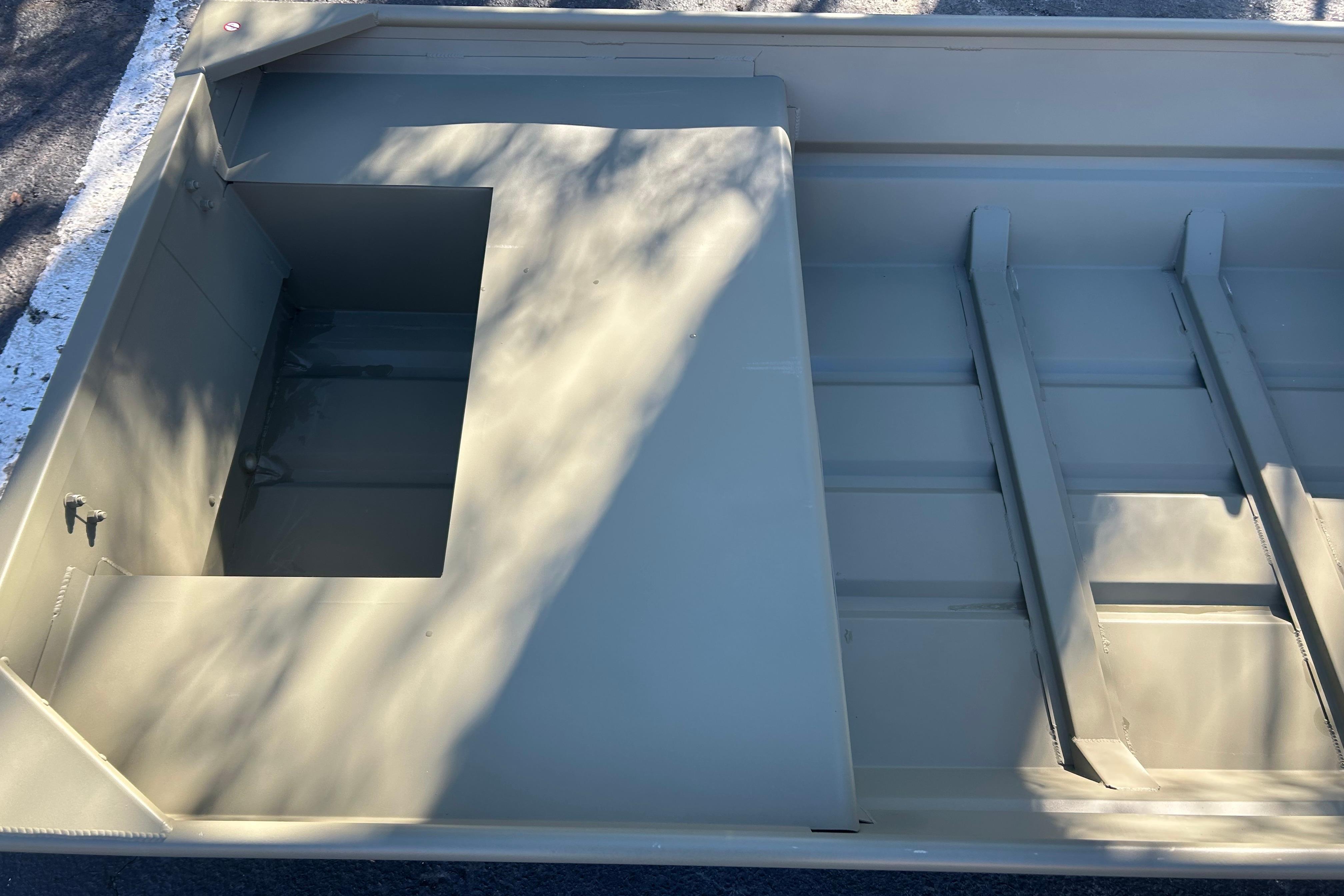 2026 Tracker Grizzly 14 Jon boat interior with open storage compartment.