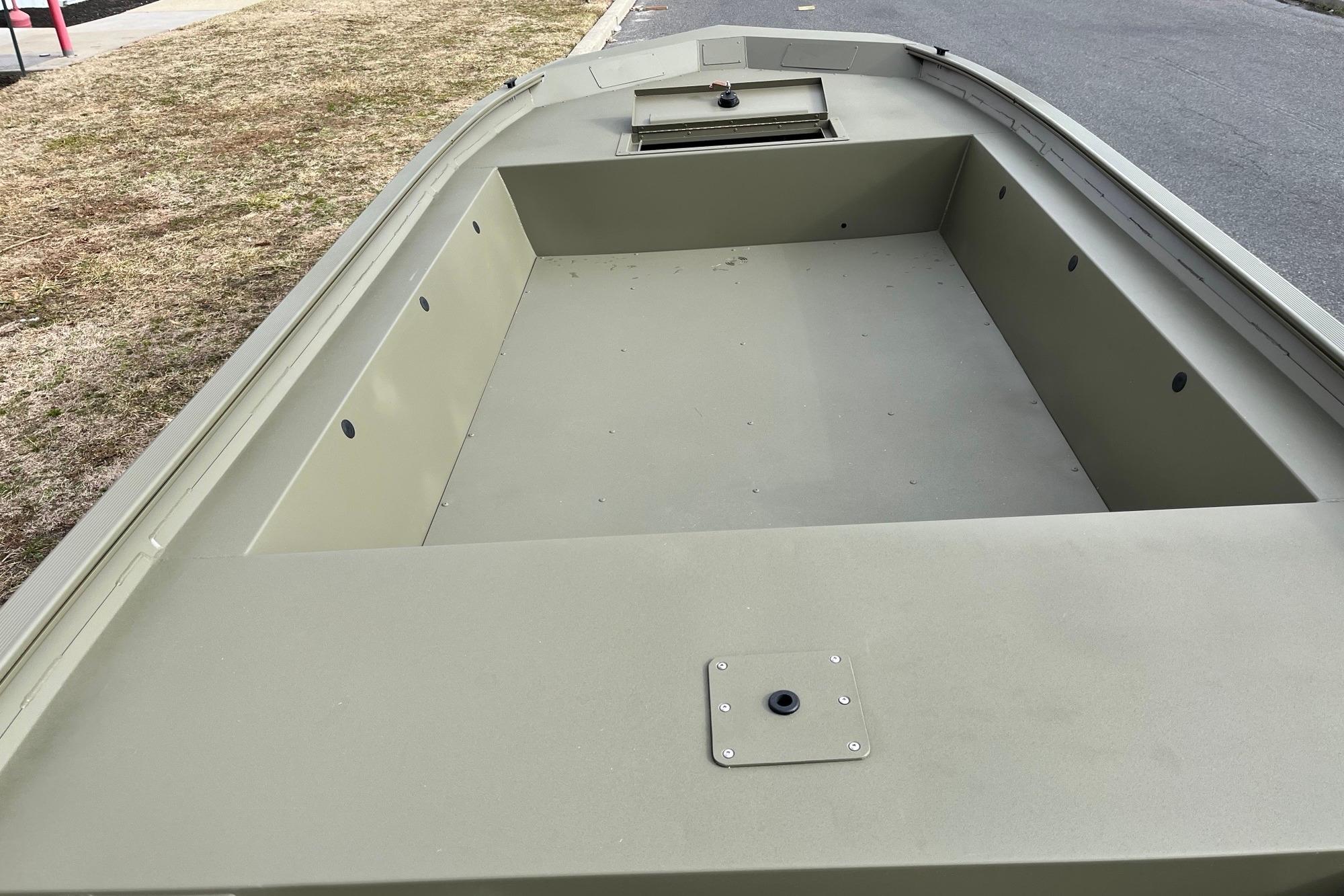 2026 Tracker Grizzly 1754 Utility boat, spacious interior, parked on roadside.