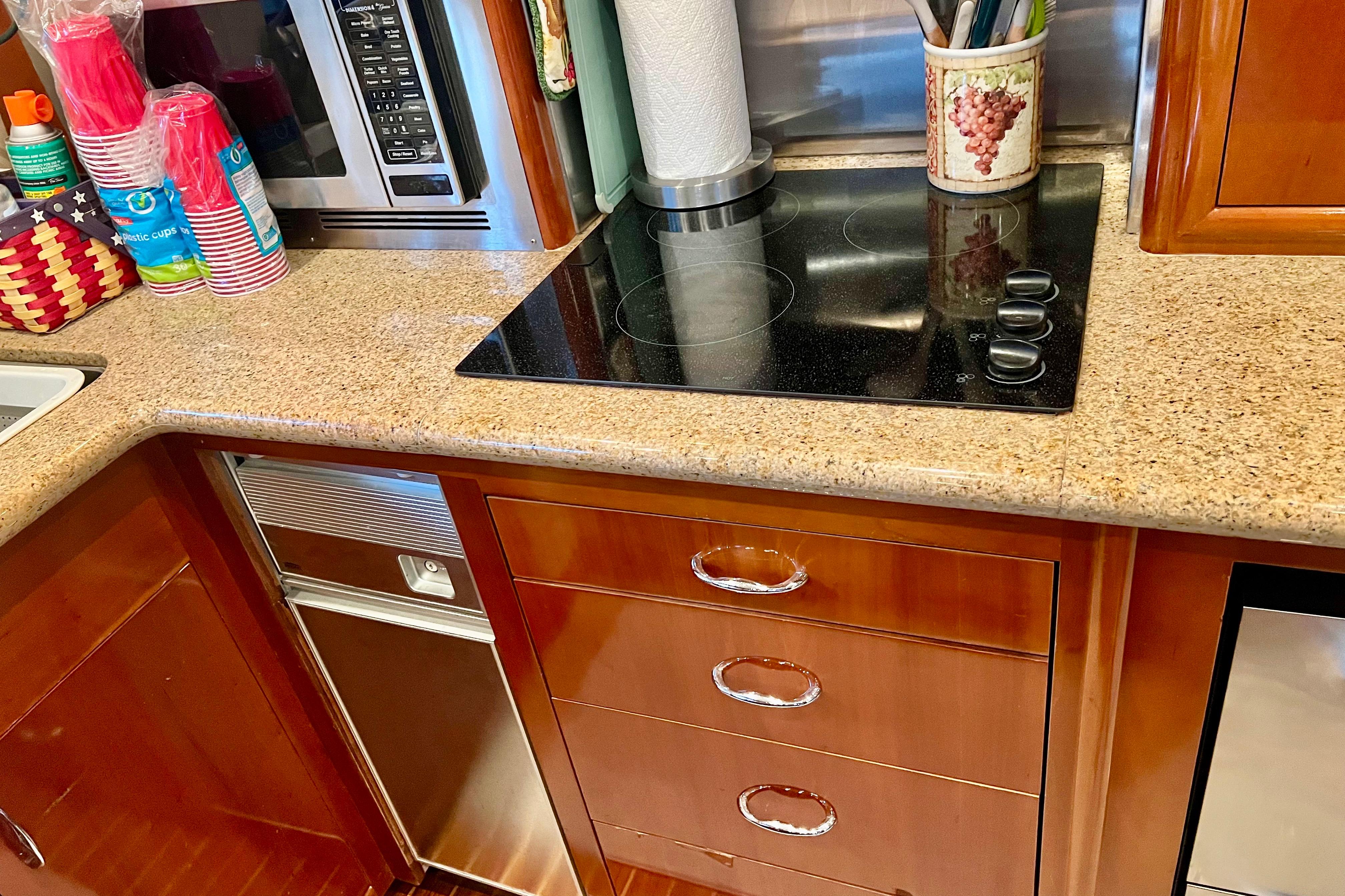 Kitchen area of a 2005 Carver 56 Voyager yacht with stove and microwave.