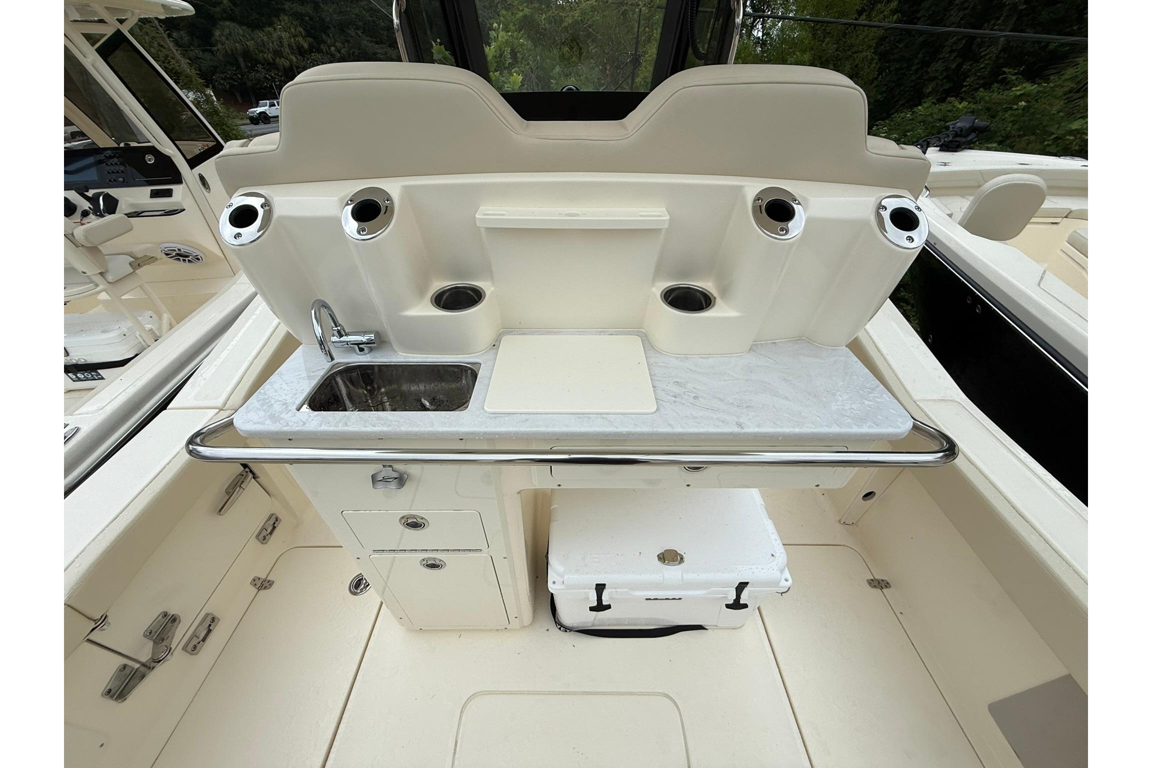 2026 Scout 260 LXF boat interior with sink, storage, and rod holders.