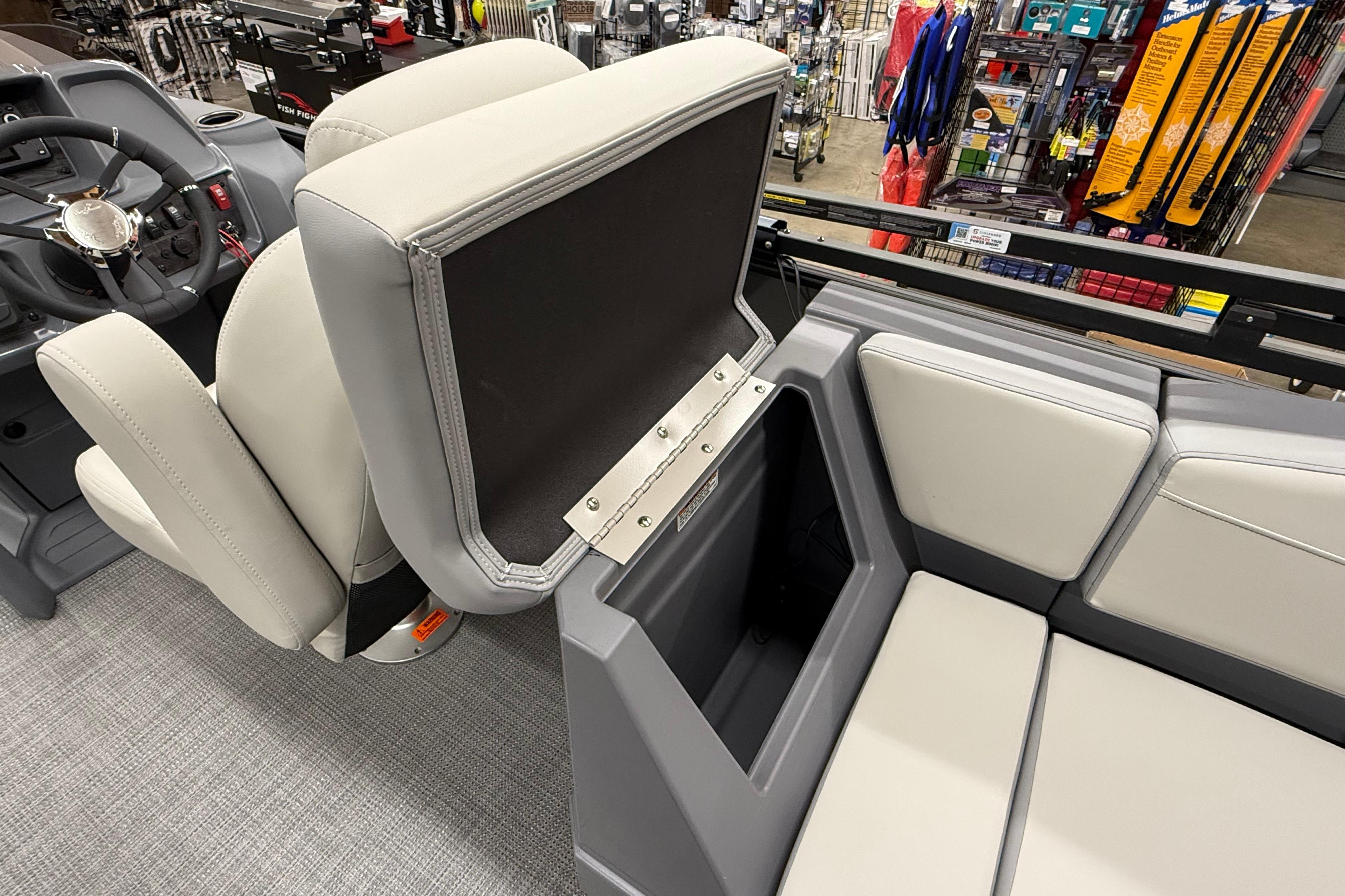 Interior of 2025 SunChaser Lucerne 22 LR DH boat with open storage compartment.