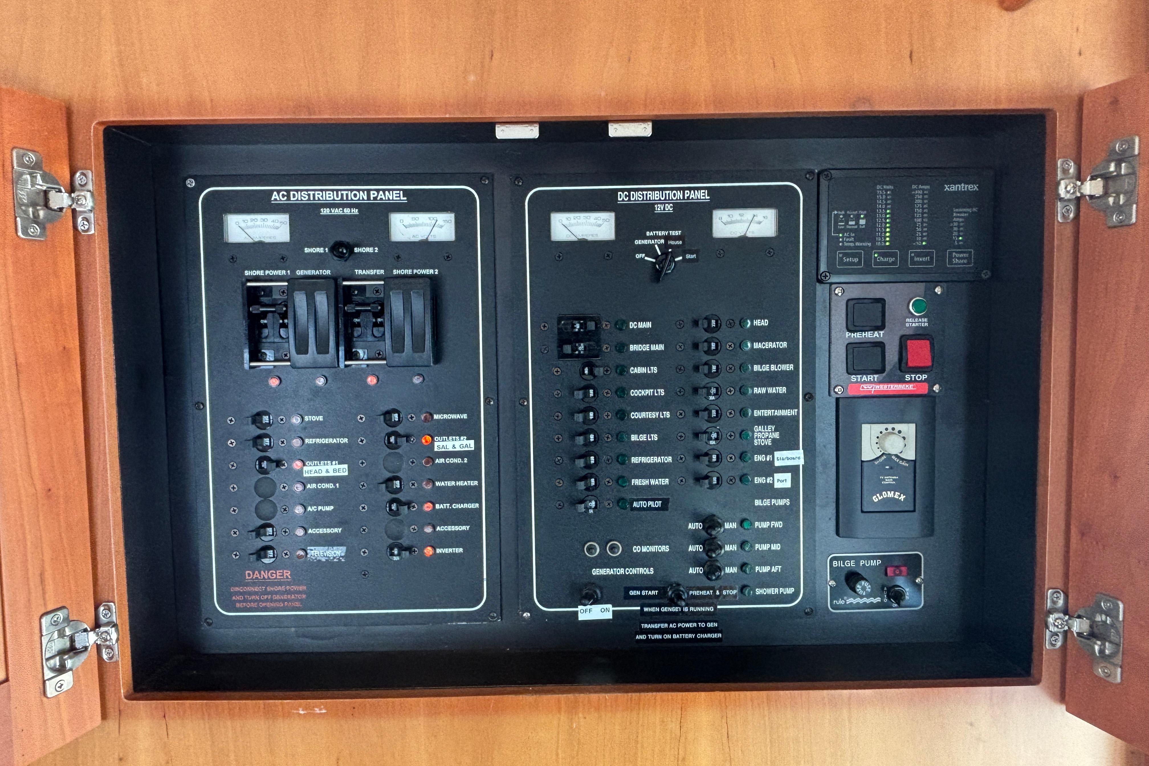 Electrical control panel on a 2007 Mainship 34 Trawler, featuring AC and DC distribution.