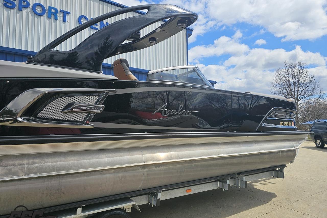 2024 Avalon Excalibur Quad Lounge Windshield boat displayed outdoors.