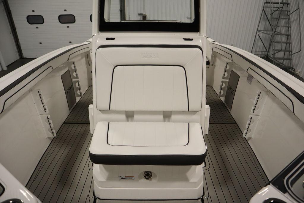 2026 Yamaha Boats 255 FSH Sport E interior with white seating and sleek design.