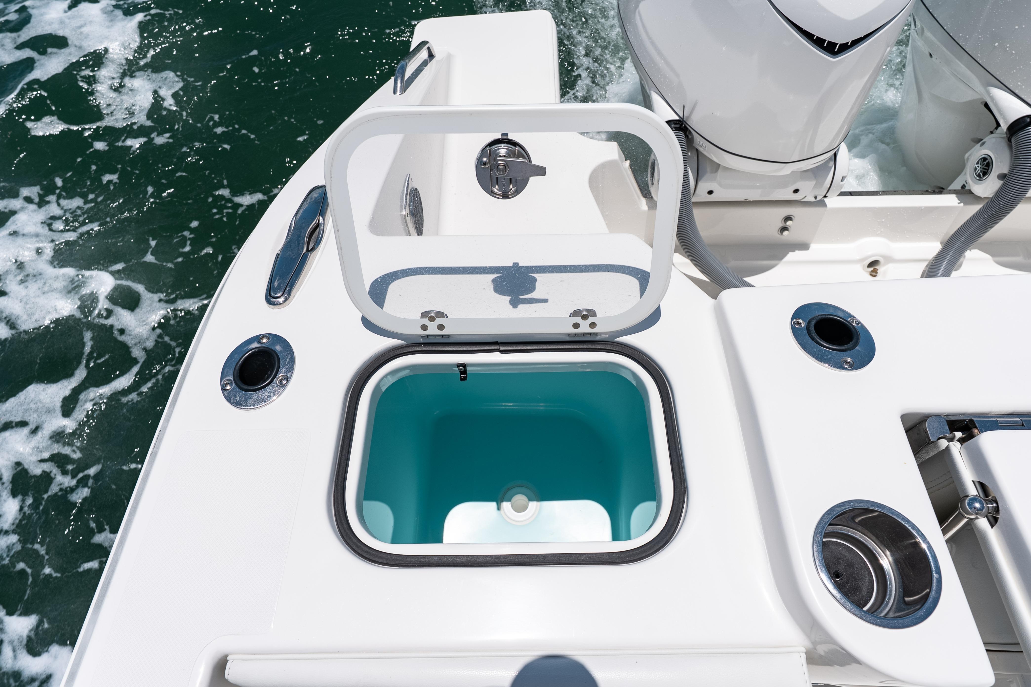 Livewell on 2026 Pursuit DC 326 Dual Console boat, open lid, ocean background.
