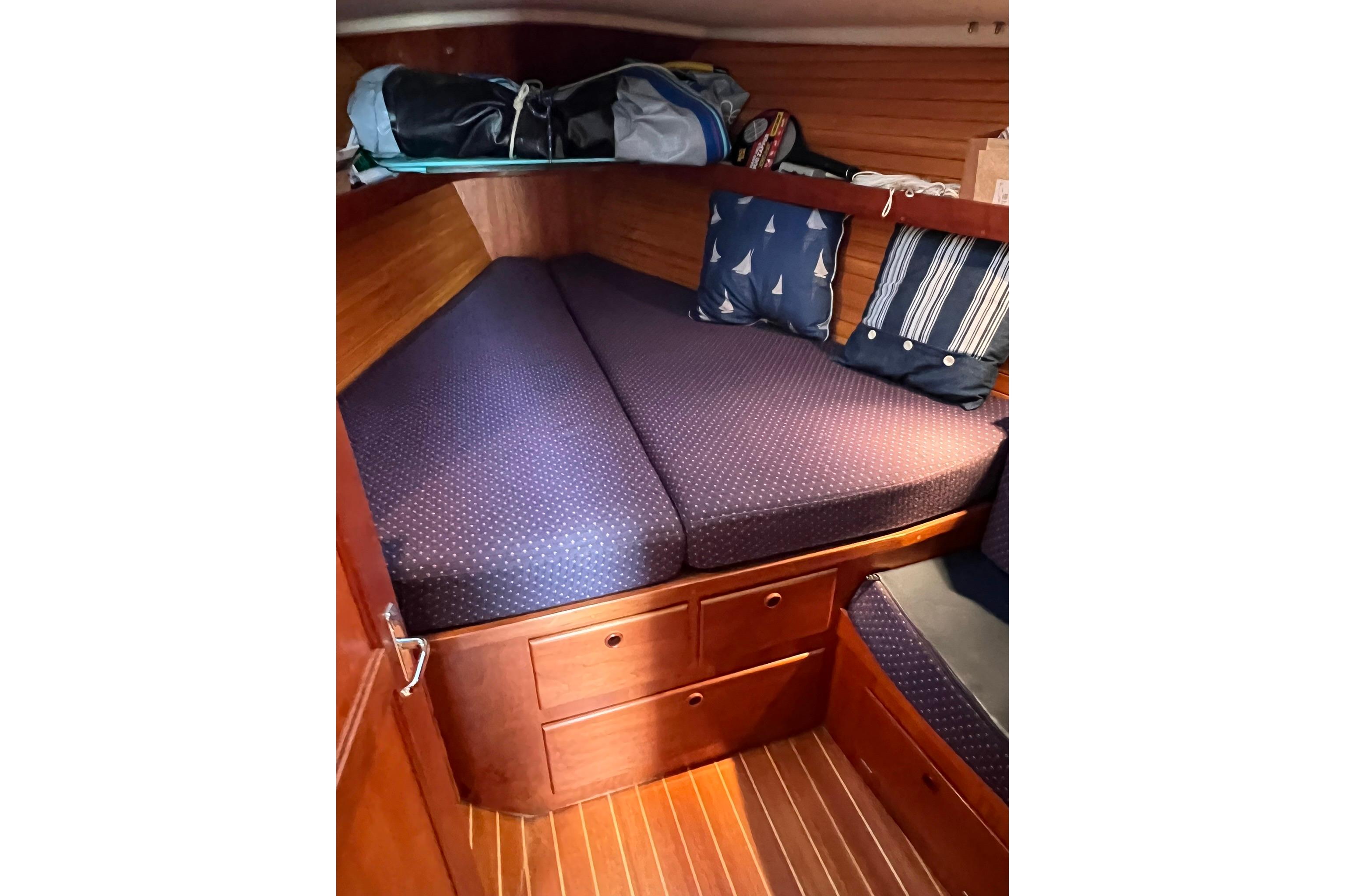 Cozy cabin interior of 1998 Sabre 362 sailboat with nautical-themed cushions.