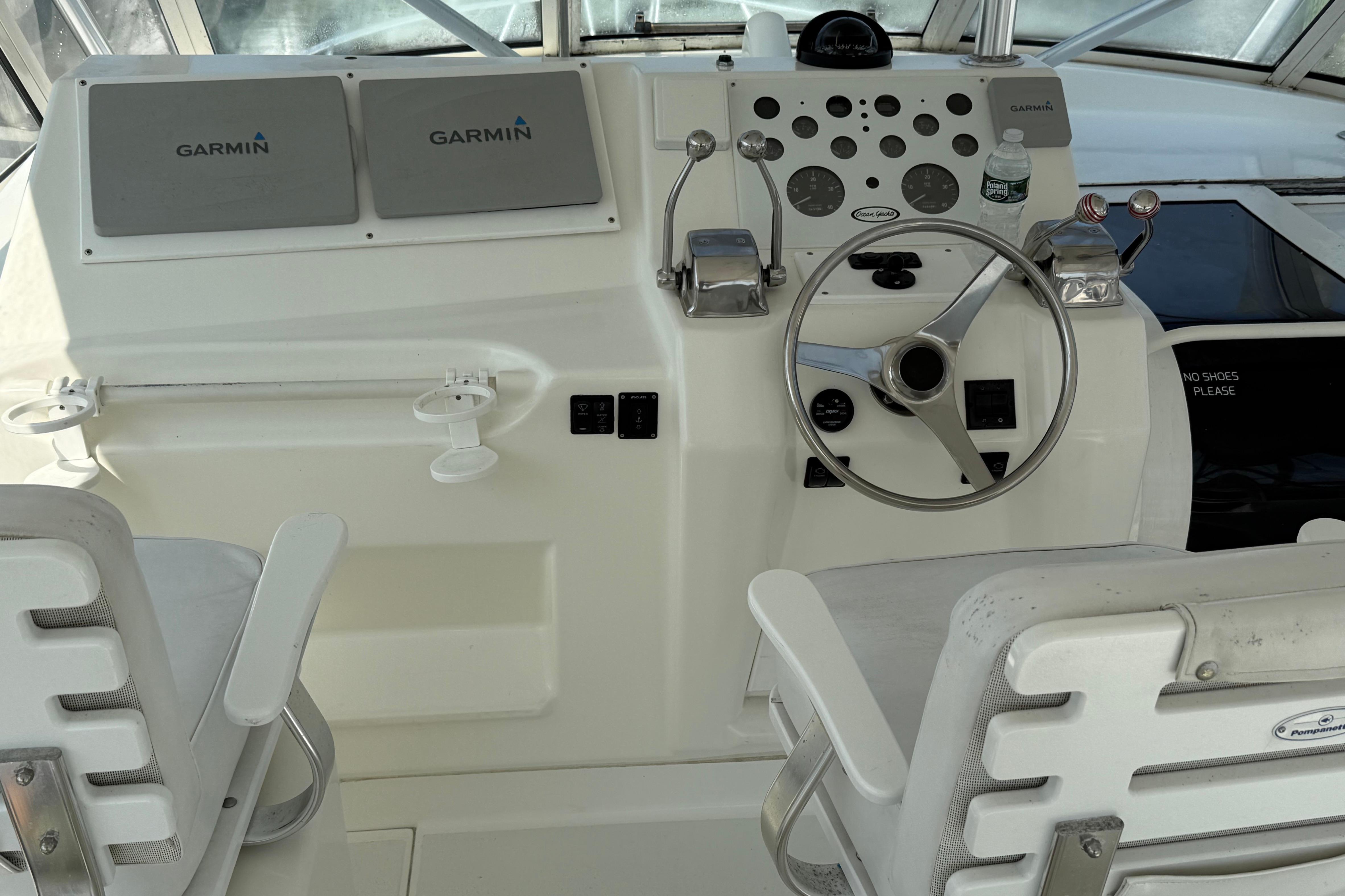 1999 Ocean Yachts 40 Express helm with Garmin displays and dual captain chairs.