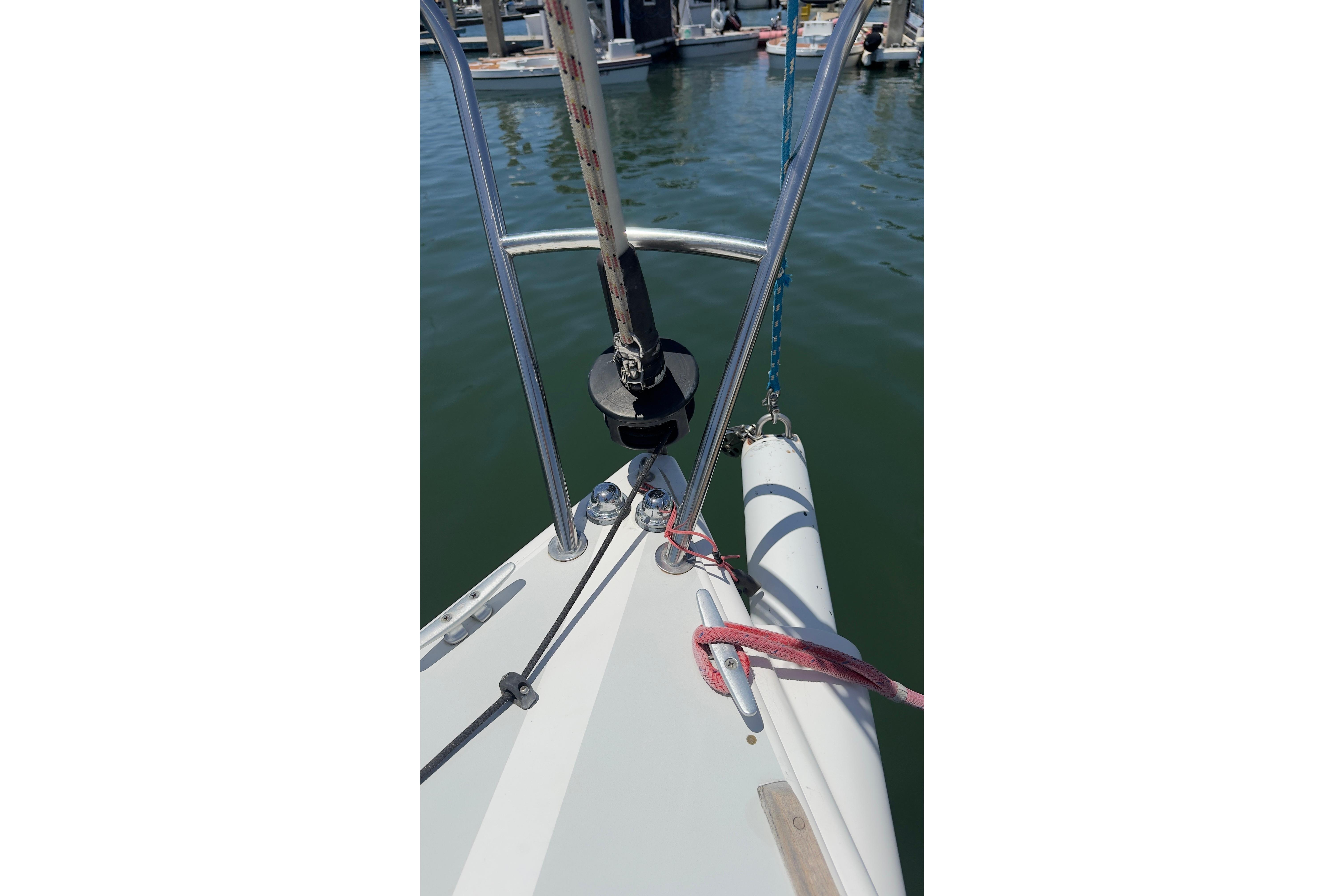 Bow of a 1994 J Boats J/92 sailboat with rigging and fender.