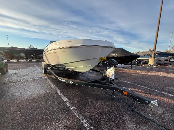2024 Tahoe T21 boat on trailer in parking lot under cloudy sky.