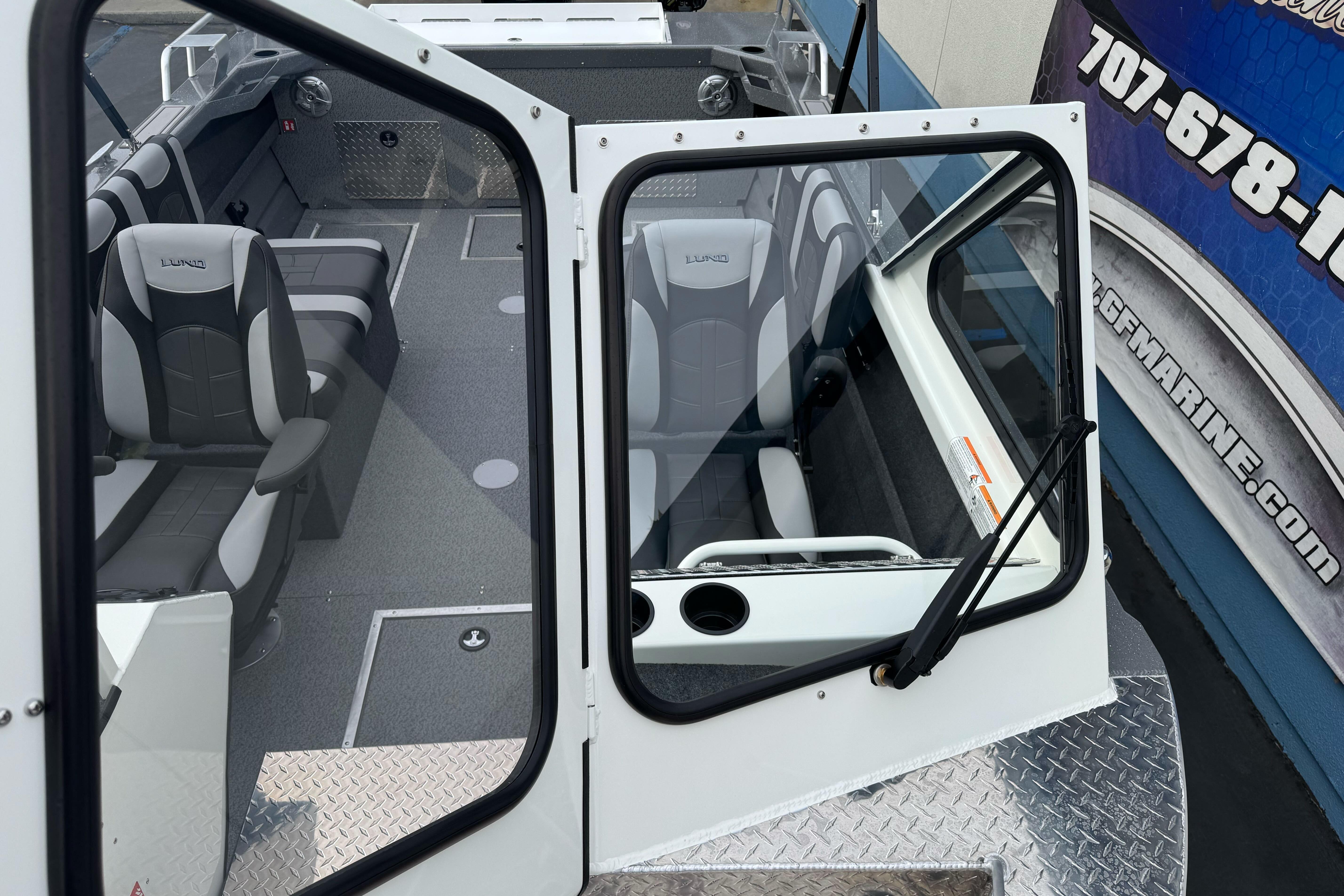 2026 Lund 185 Heavy Gauge boat interior with modern seating and windshield view.