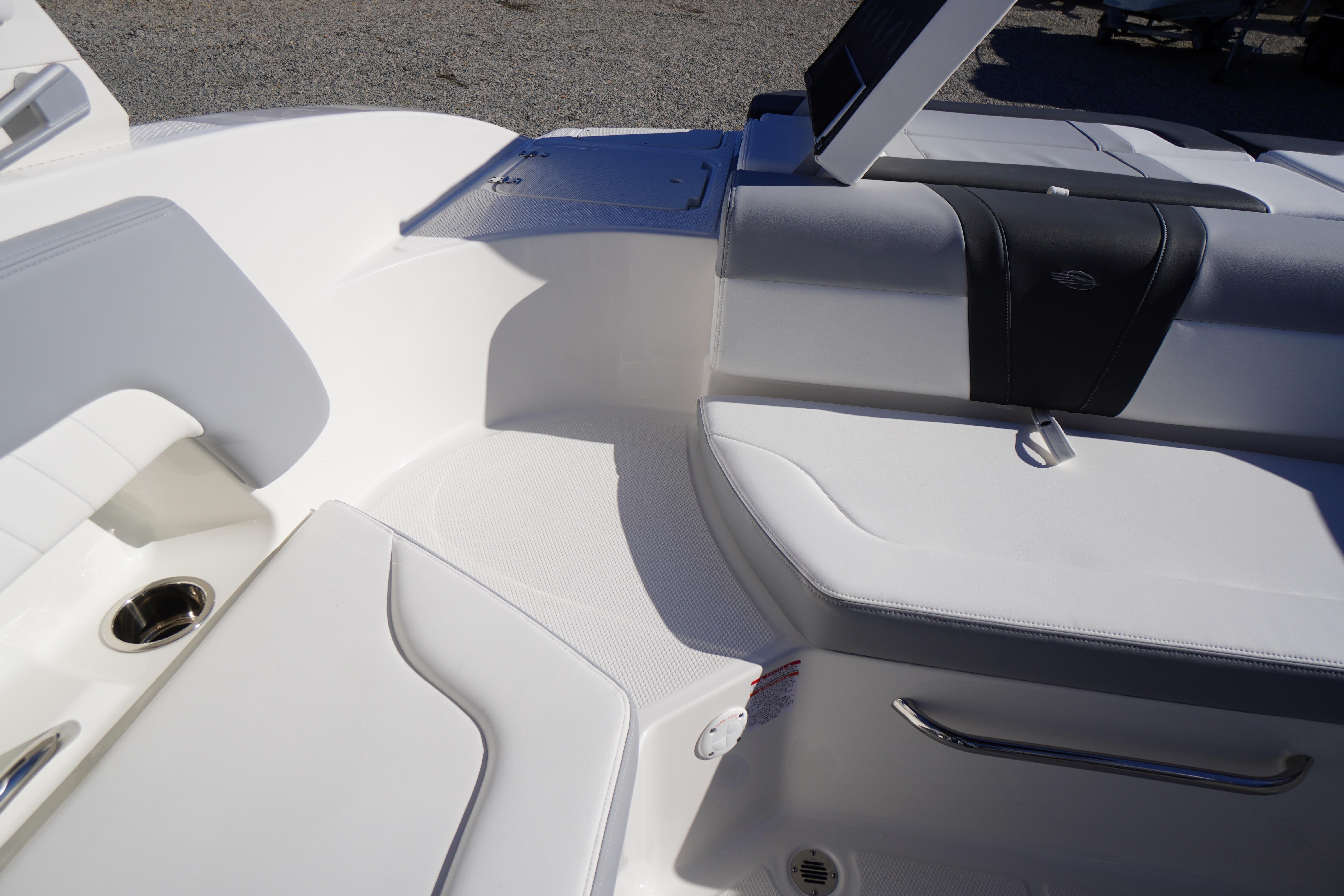 Interior seating of 2026 Chaparral 23 SSi boat, featuring sleek white upholstery.