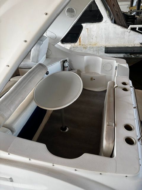 Interior of a 2002 Bayliner 2855 with table and seating area.