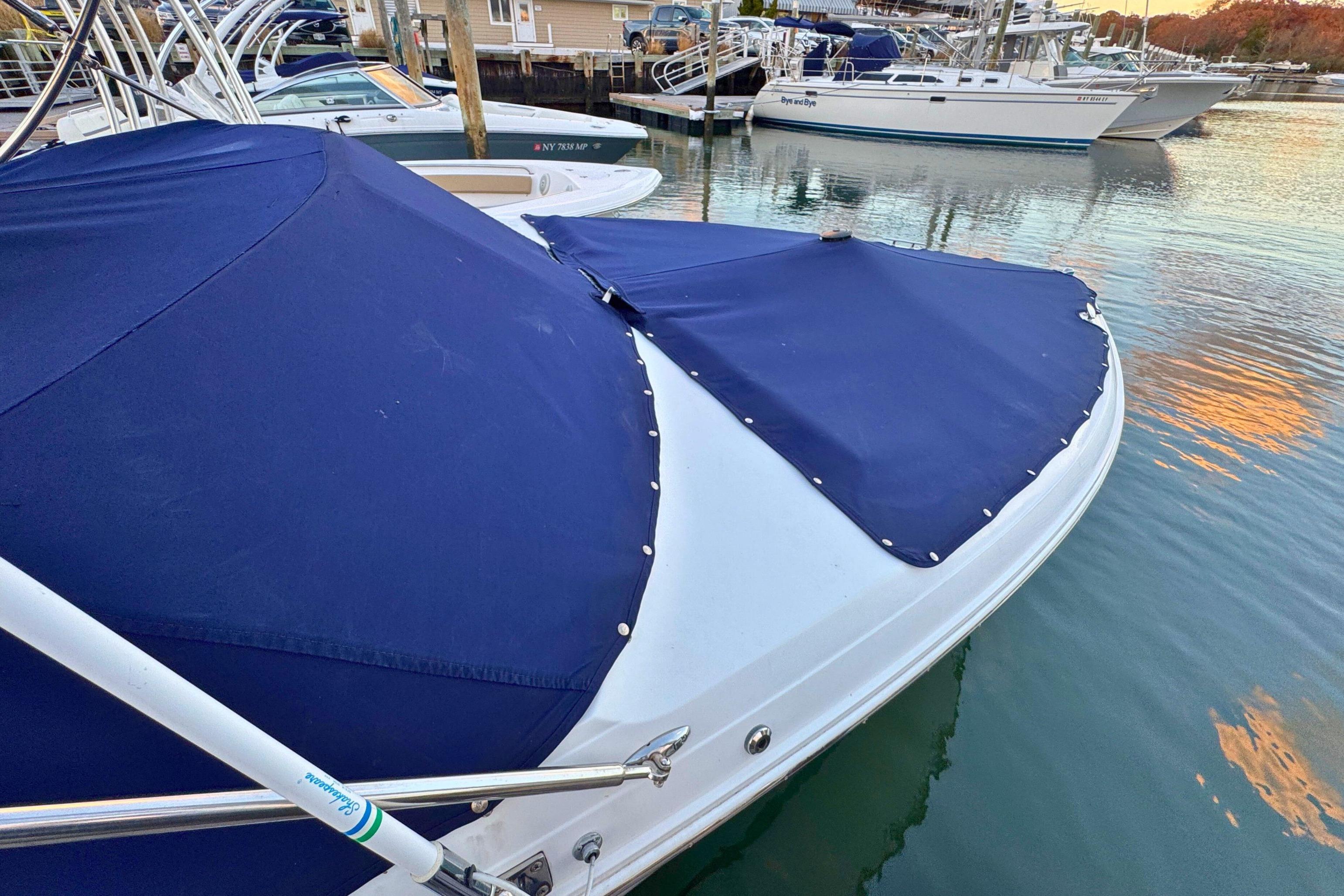 2019 Cobalt R3 boat with blue cover docked in marina.