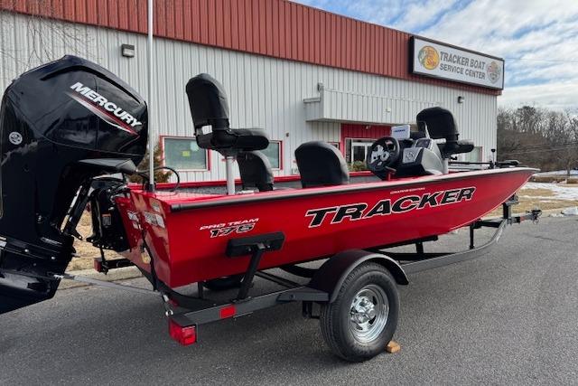 2026 Tracker Pro Team 175 Crappie Edition boat at service center, red exterior.