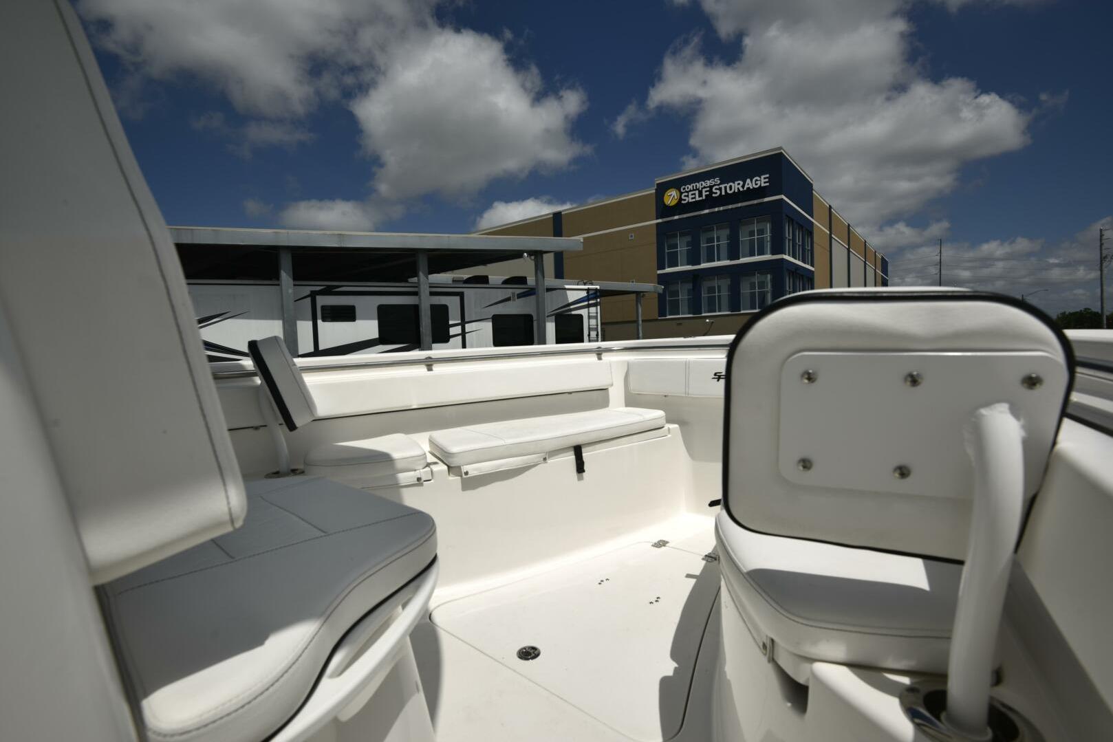 2023 Sea Pro 239 Deep V CC boat interior with storage facility in background.