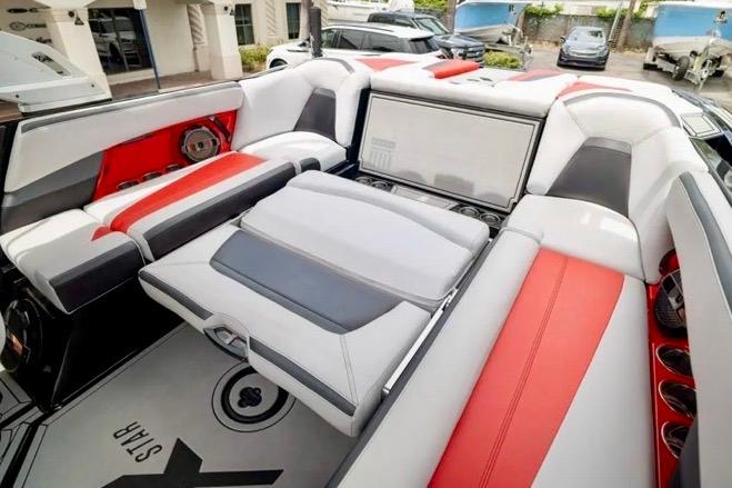 2019 MasterCraft XStar boat interior with red and gray seating, showcasing luxury and comfort.