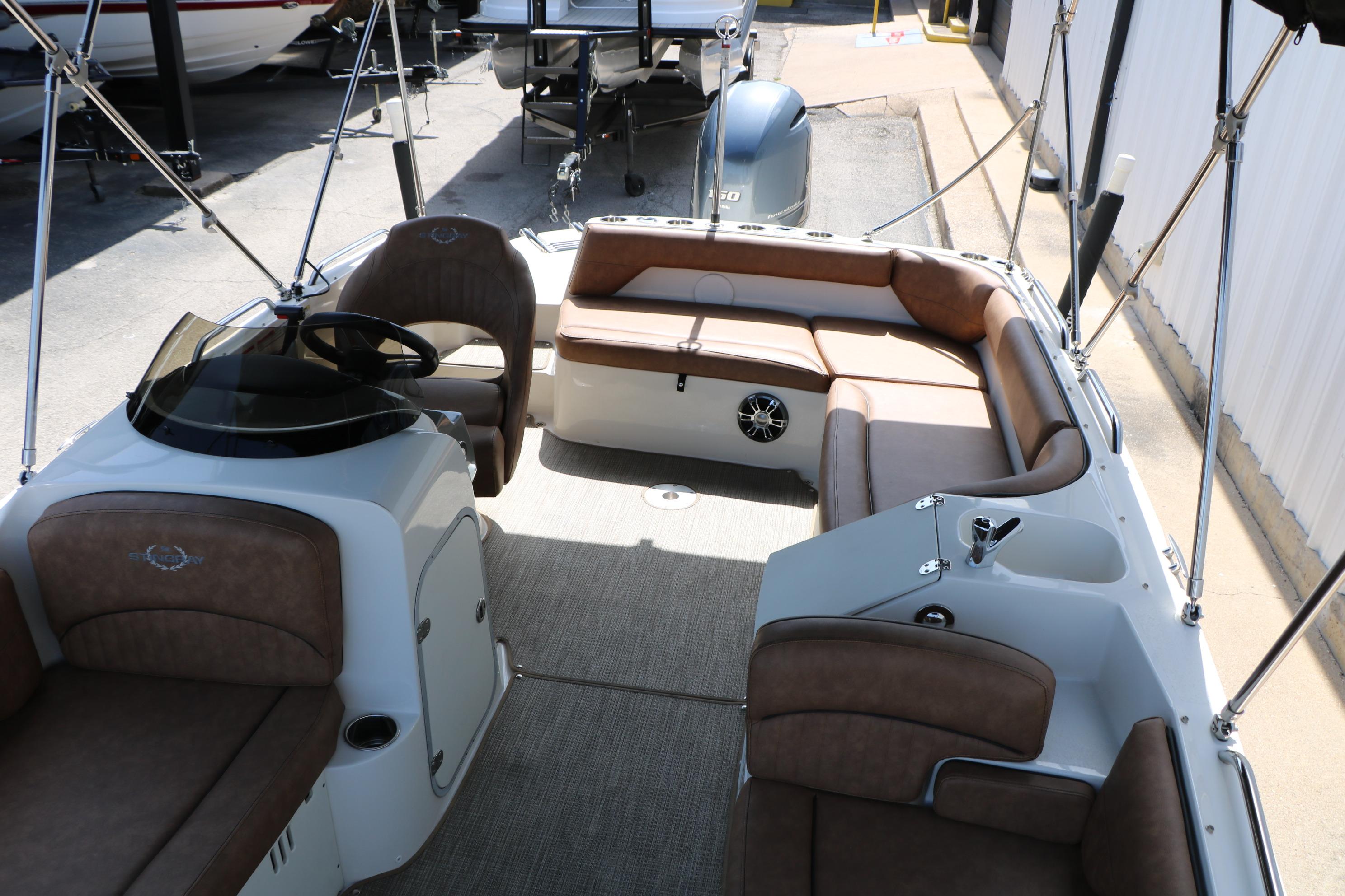 2022 Stingray 192 SC boat interior with brown seating and steering console.