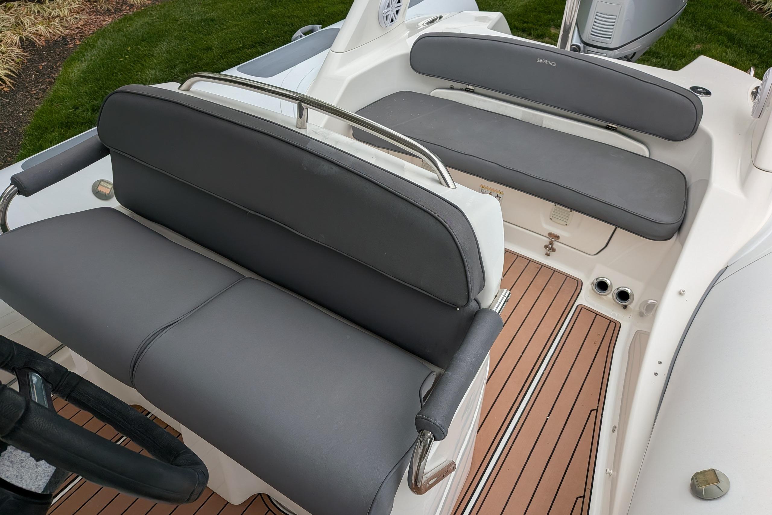 2016 Brig E780 boat interior with gray seating and teak-style flooring.