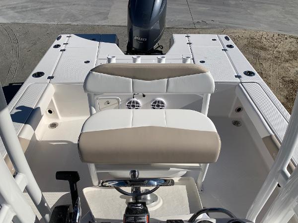 2024 Robalo 226 Cayman boat interior with cushioned seating and outboard motor.
