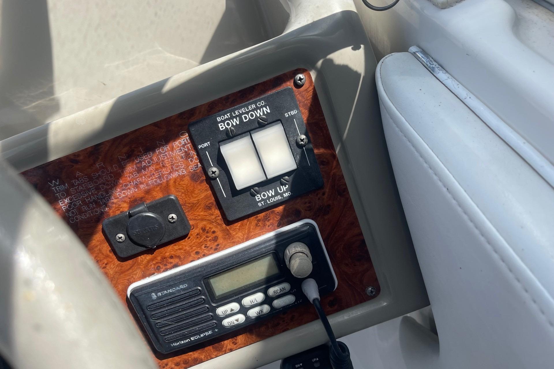 Control panel of a 1997 Bayliner 2655 Ciera boat with trim tab switches.