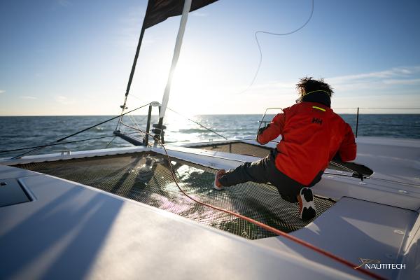 Person sailing on Nautitech 48 Open catamaran, 2025 model, enjoying the ocean view.