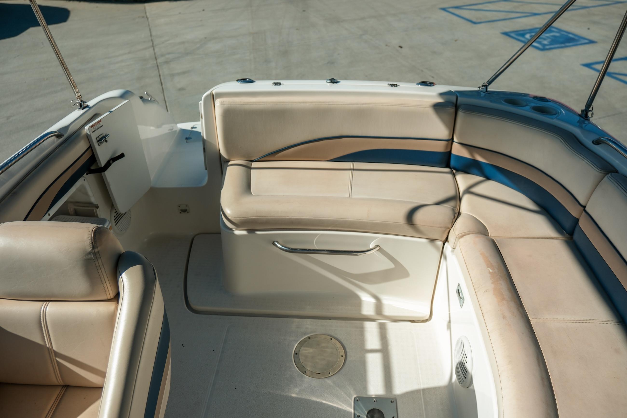 1998 Chaparral 232 Sunesta boat interior with beige seating and spacious layout.