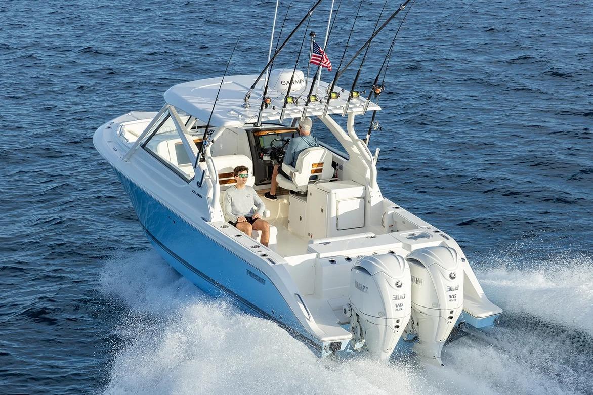 Manufacturer Provided Image: 2026 Pursuit DC 286 Dual Console boat cruising on open water with fishing rods.